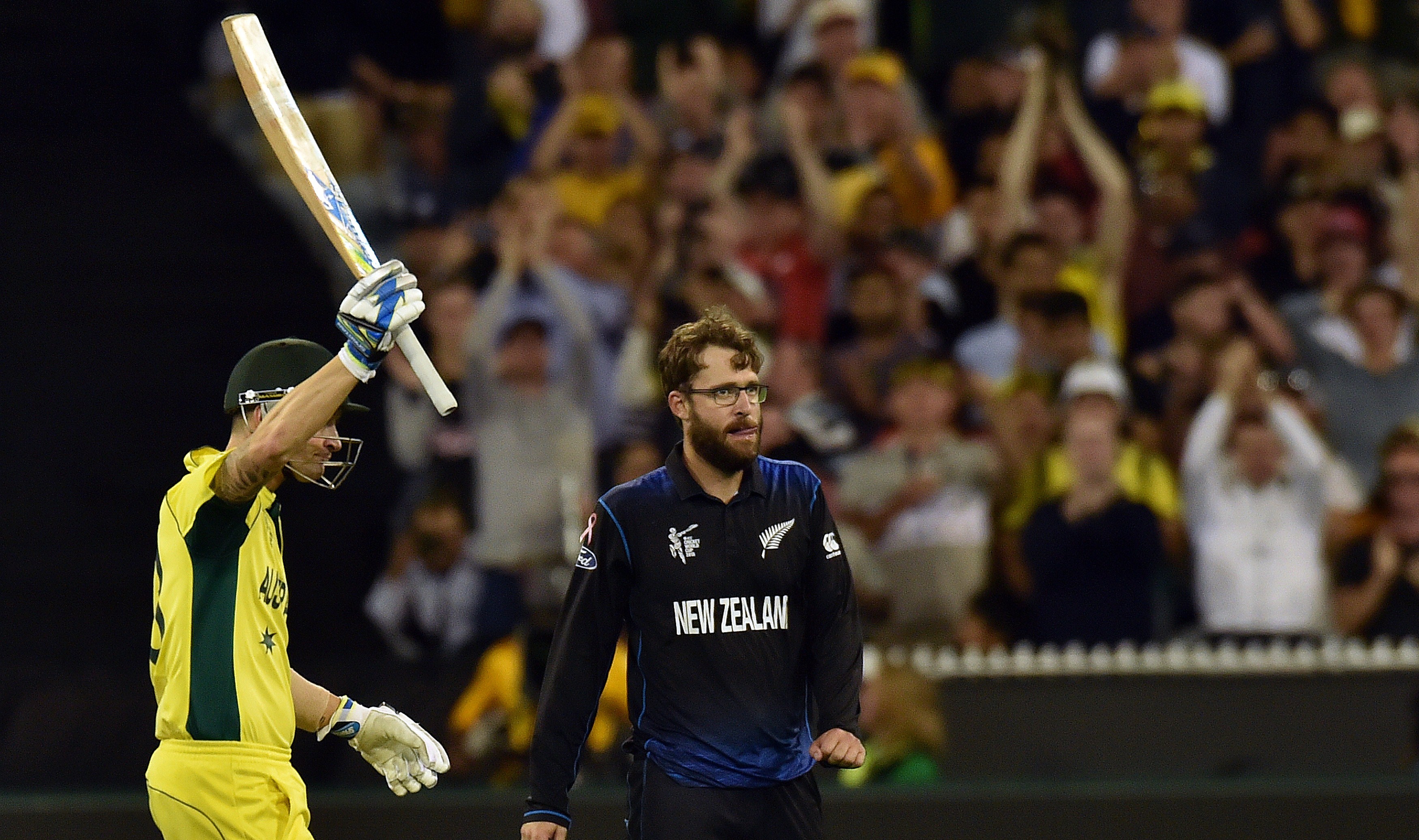 Australia's batsman Michael Clarke celebrates his half century as New Zealand's spin bowler Daniel Vettori looks on during the 2015 Cricket World Cup final. Photo / Getty Images