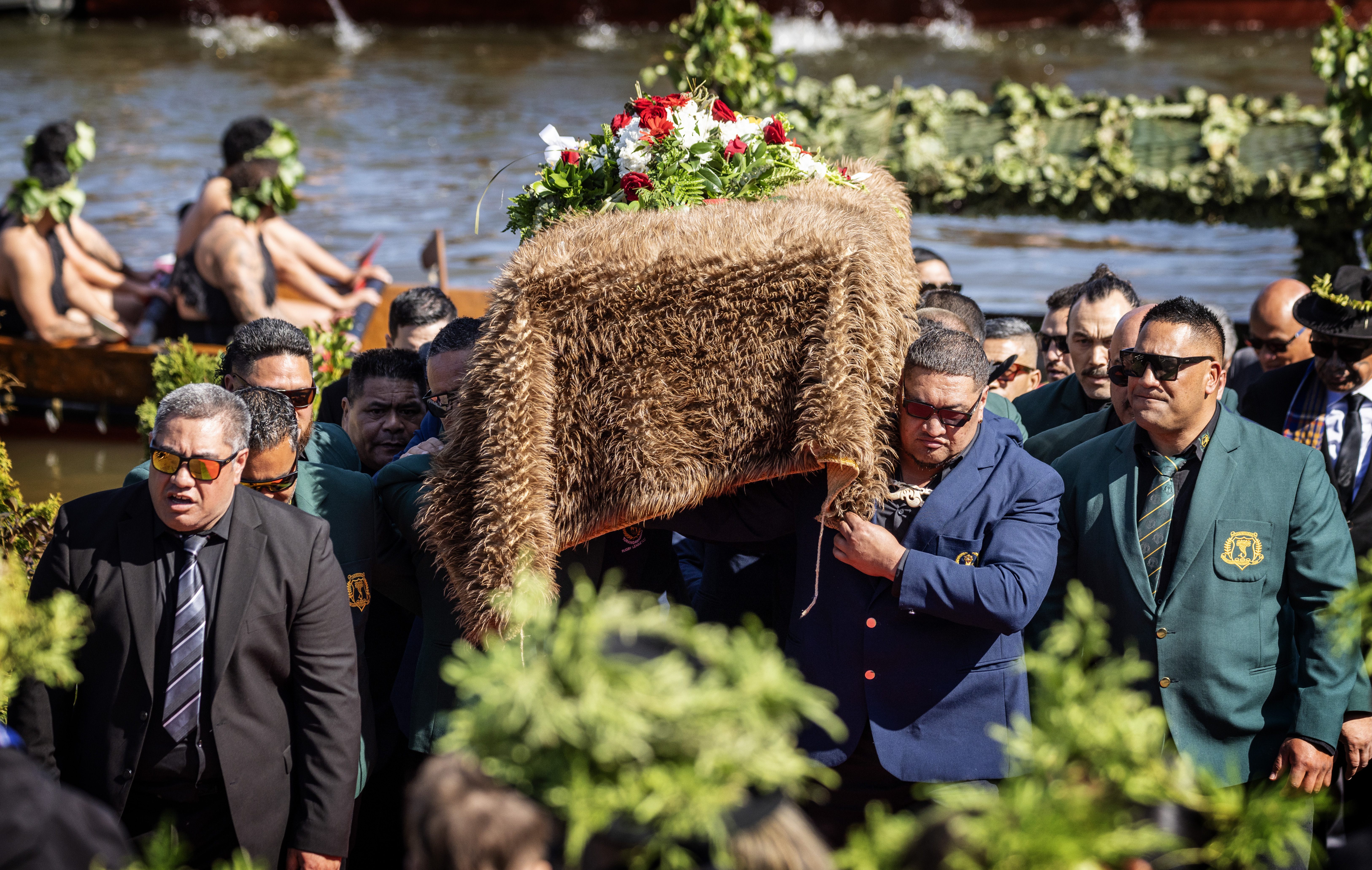 Kīngi Tūheitia's coffin is lifted off the waka before being taken up the maunga. Photo / Mike Scott