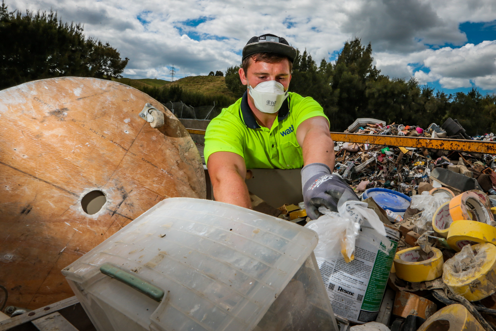 Meeanee resident Jake Haszard dumps his work gear, contaiminated by floodwaters during Cyclone Gabrielle. Photo / Paul Taylor