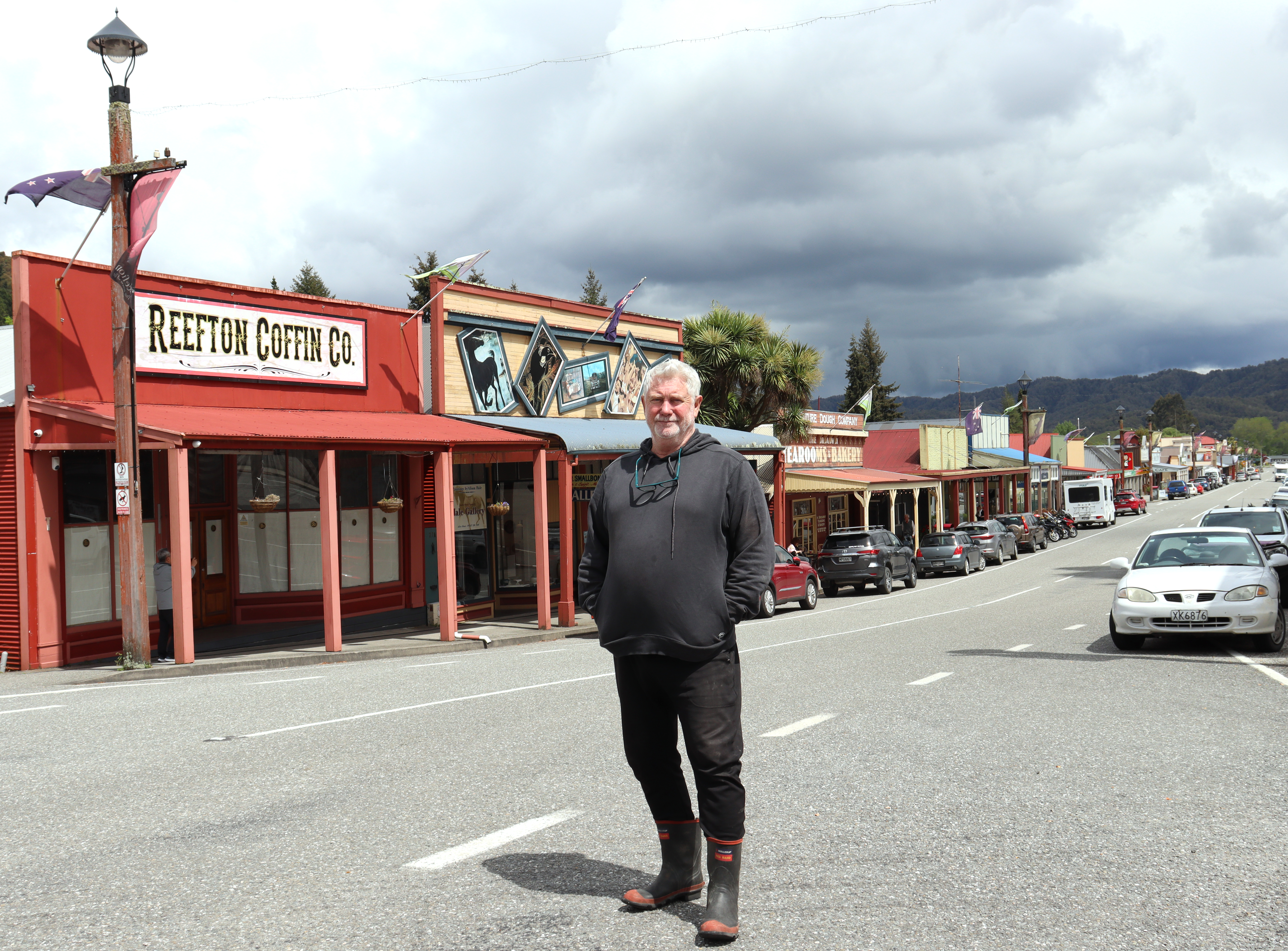 Businessman John Bougen on the main street of Reefton in front of one of his businesses, Reefton Coffin Co, which is to be turned into an Italian restaurant/pizzeria, opening in January 2024. Photo / Kelsey Manawatu