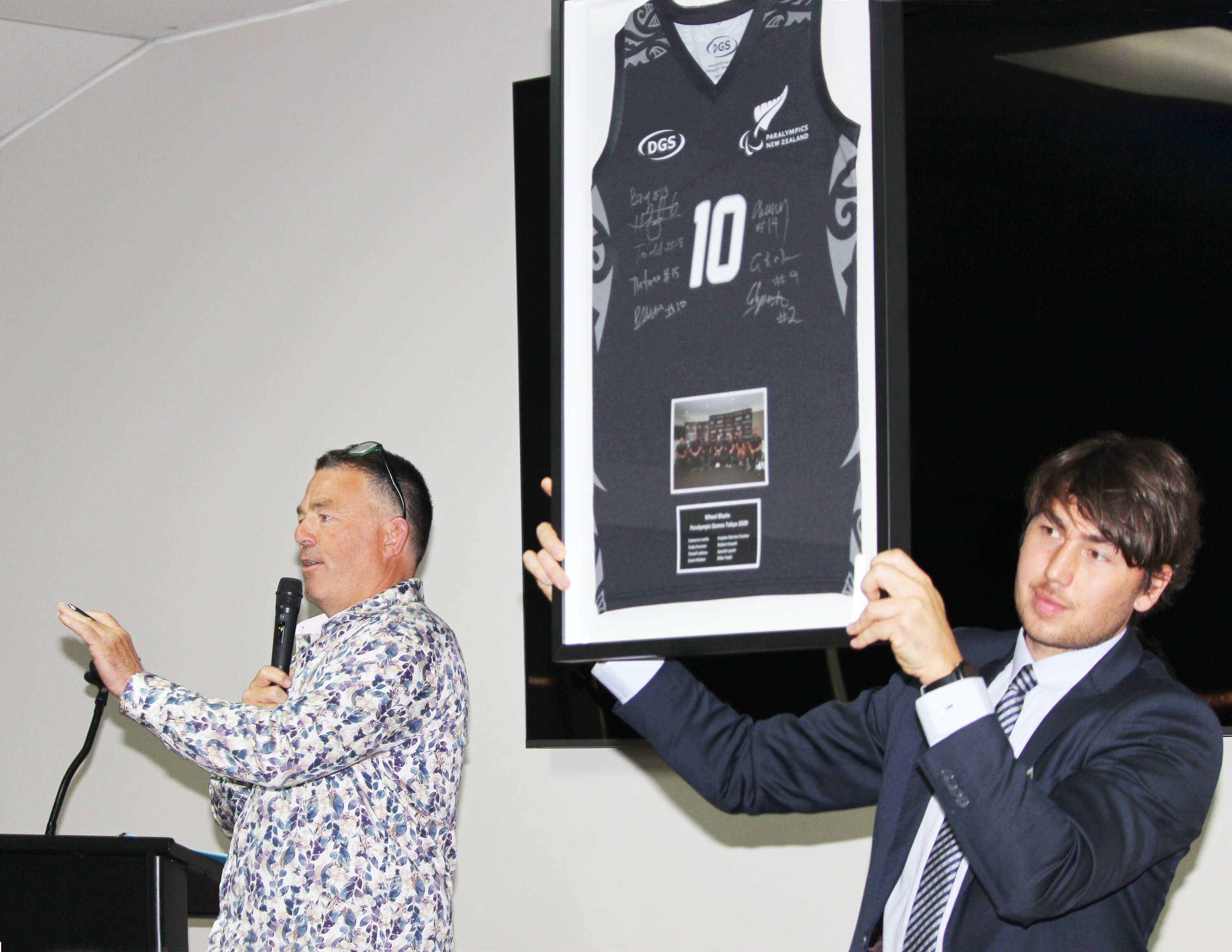 Cornerstone grant recipient Cole McOnie (BMX) holds a piece of sports memorabilia auctioned by Andy Transom. Photo / Cathy Asplin 