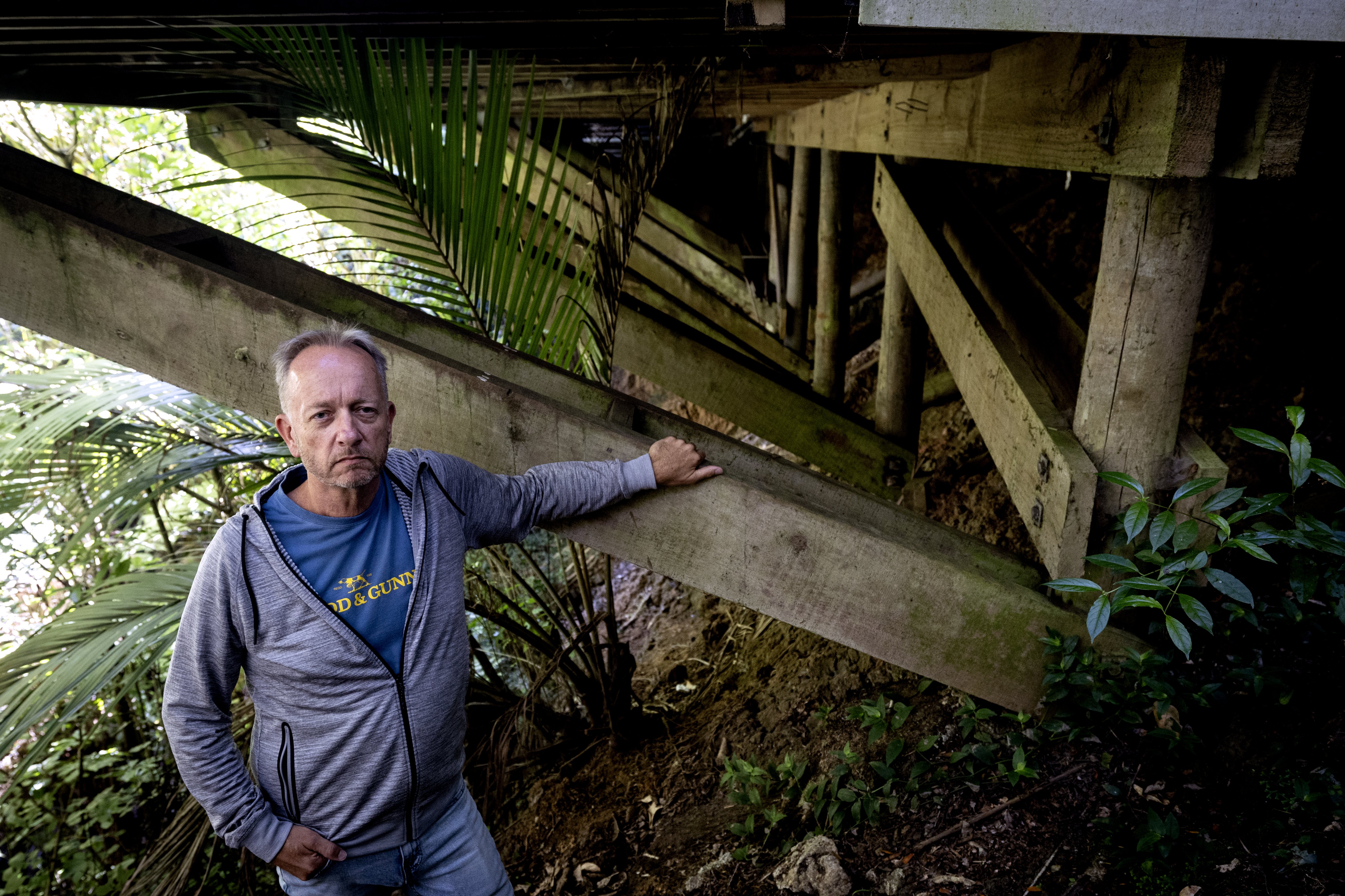 Some of the piles of Chris Whyman's Titirangi home are now exposed as a result of a landslip caused by the anniversary floods last year. Photo / Jason Oxenham
