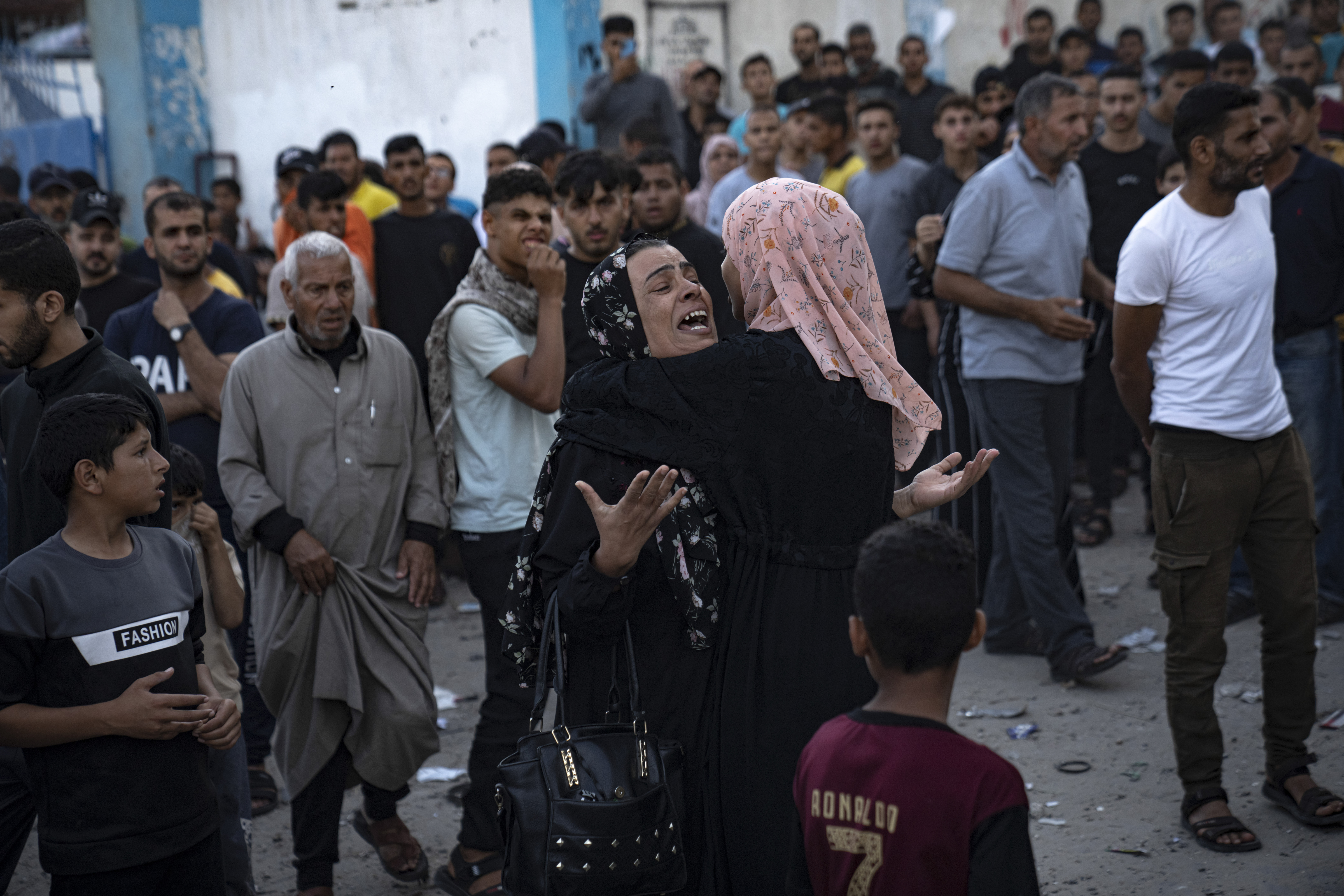 Crying women hug as victims are being pulled from the rubble of a building, which collapsed after an airstrike in Khan Younis, Gaza Strip. Photo / AP