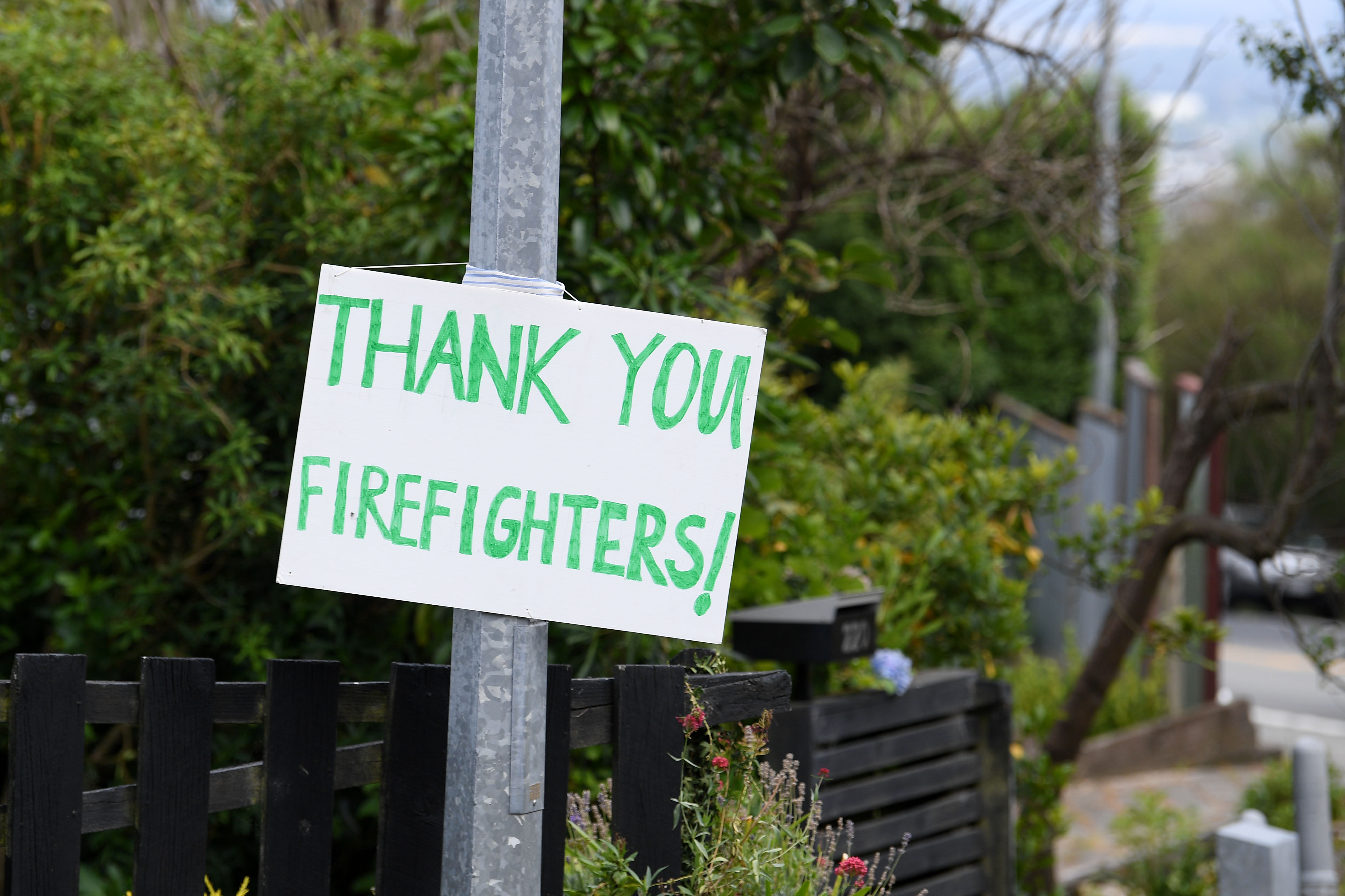 A Thank You Firefighters sign is seen on Dyers Pass Rd. A large fire has broken out in Chritchurch’s Port Hills, causing mass evacuations. Photo / Joe Allison