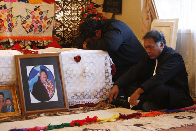 Family members grieve at the casket of Folole Muliaga, who died after electricity was cut off to their home because the bill was not paid. Photo / Glenn Jeffrey