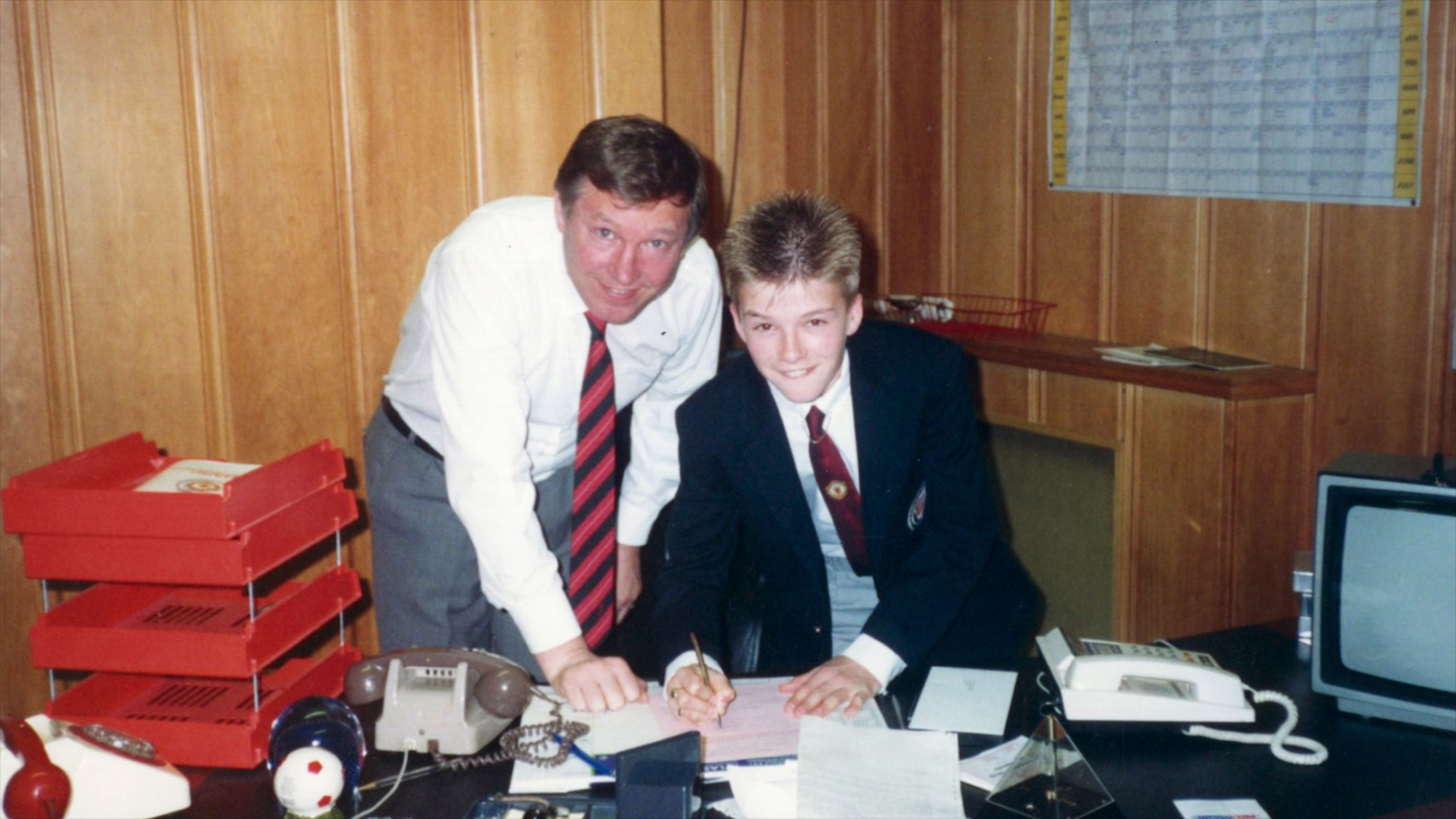 David Beckham at 14, with Manchester United manager Alex Ferguson, signing for the club. Photo / Netflix