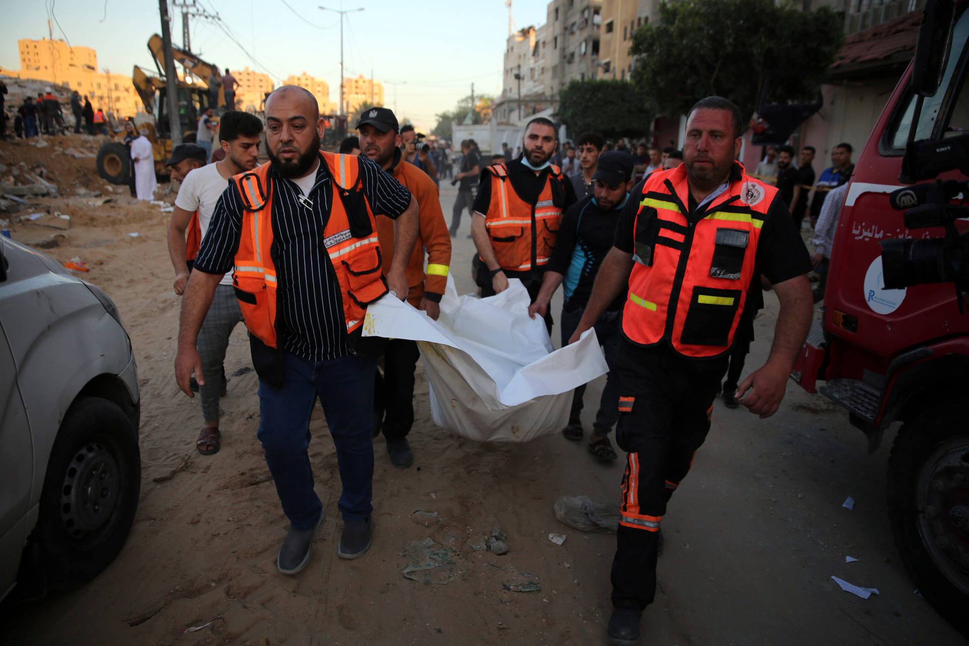 Palestinians carry the body of a child found in the rubble of a house belonging to the Al-Tanani family, that was destroyed in Israeli airstrikes in town of Beit Lahiya. Photo / AP