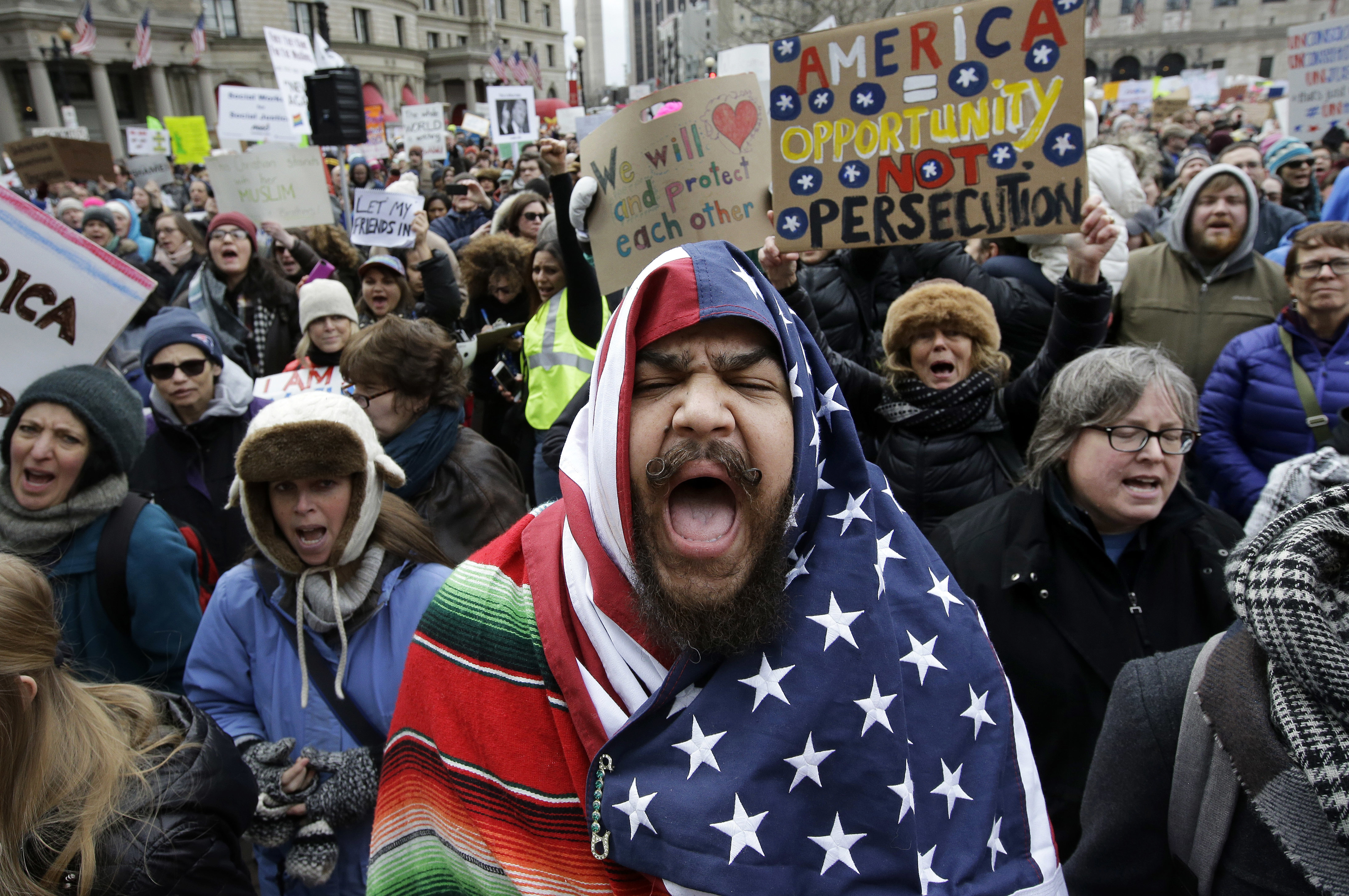 Izzy Berdan, of Boston, chants slogans with other demonstrators during a rally against President Donald Trump's order. Photo / AP