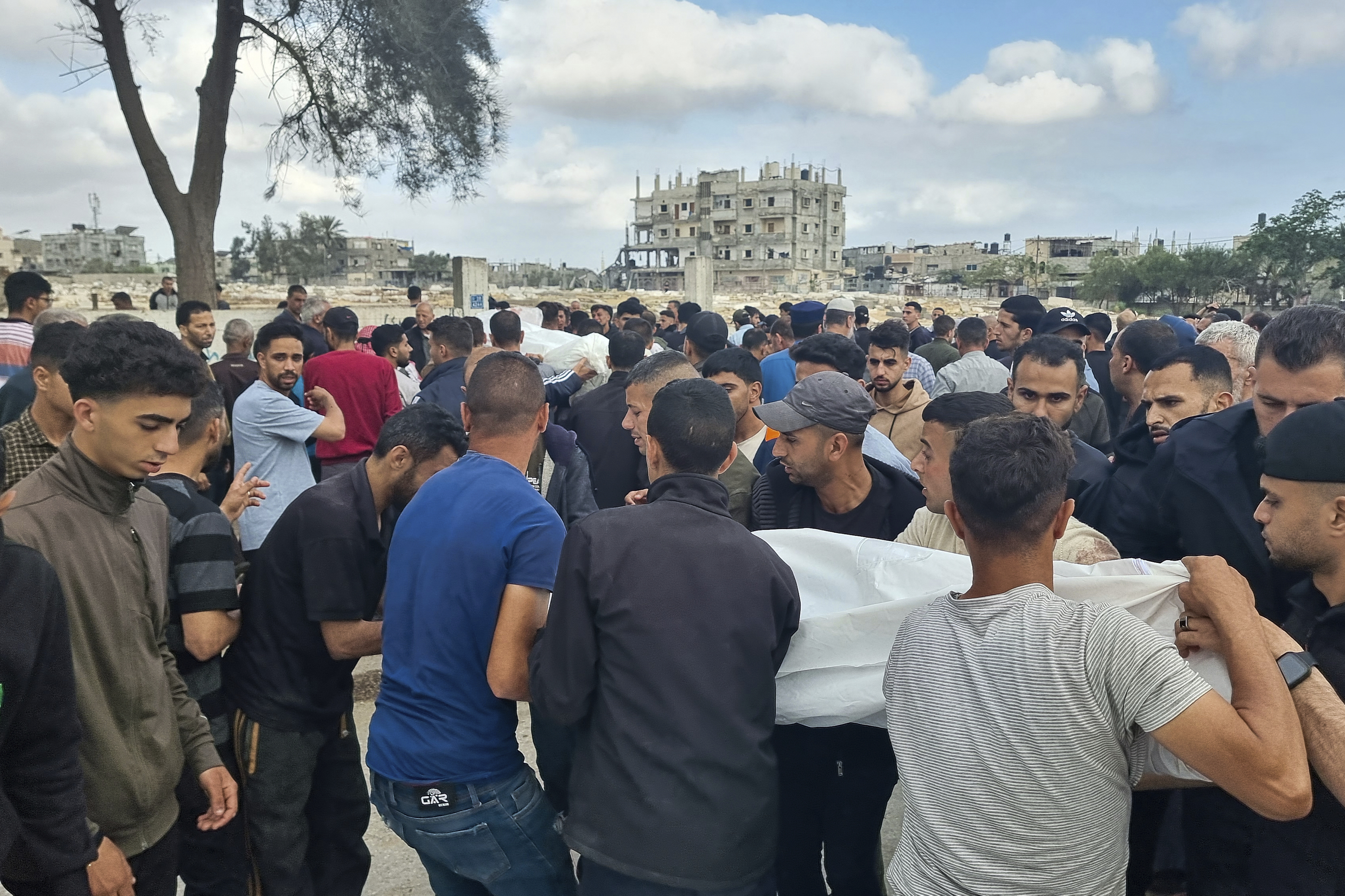 Mourners carry the bodies of members of the Abu Taha family who were killed in an Israeli airstrike, during their funeral at Al-Salam cemetery, east of Rafah, Gaza Strip. Photo / AP