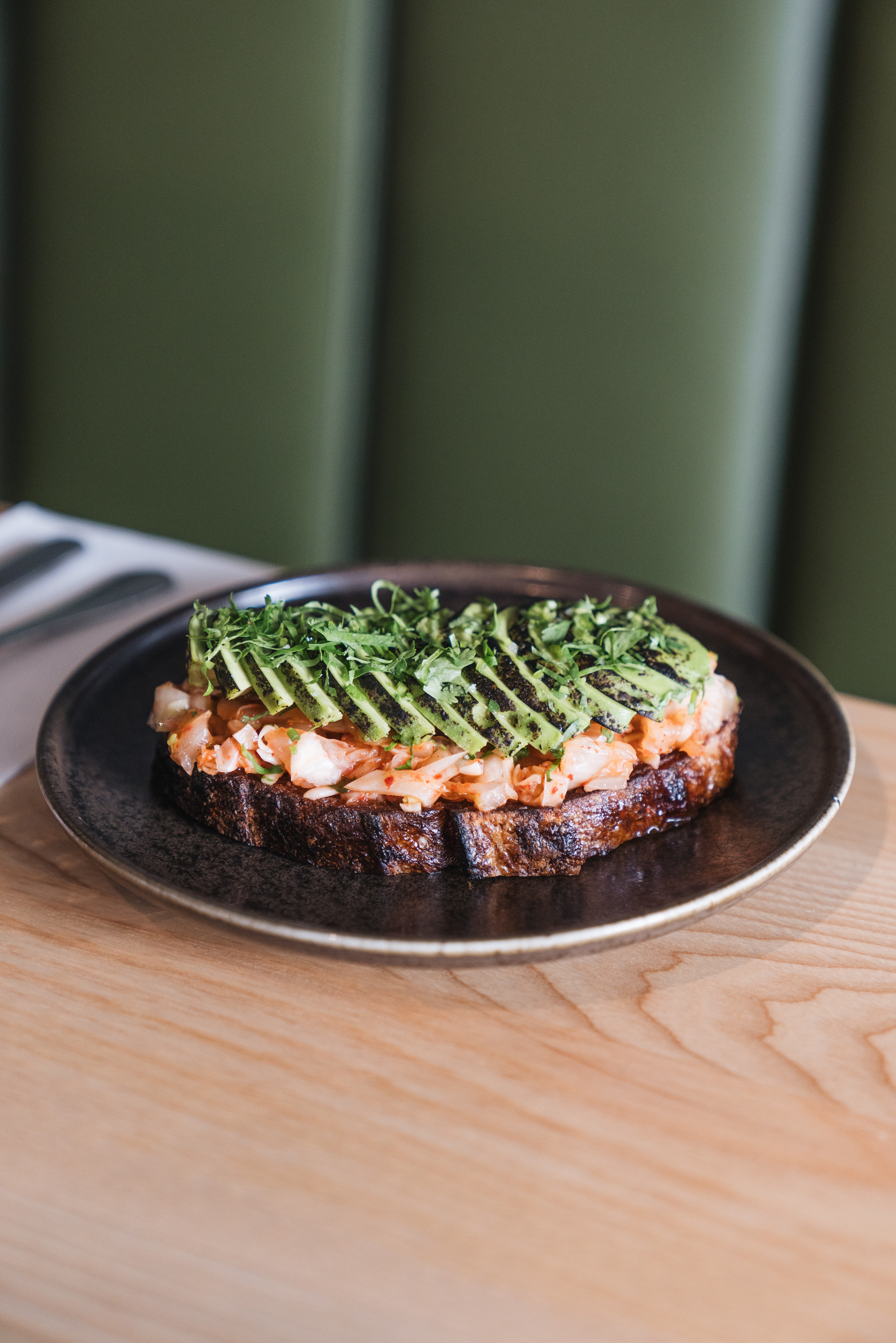 Charred avocado toast with coriander and kimchi from Rhu in Parnell. Photo / Rhu