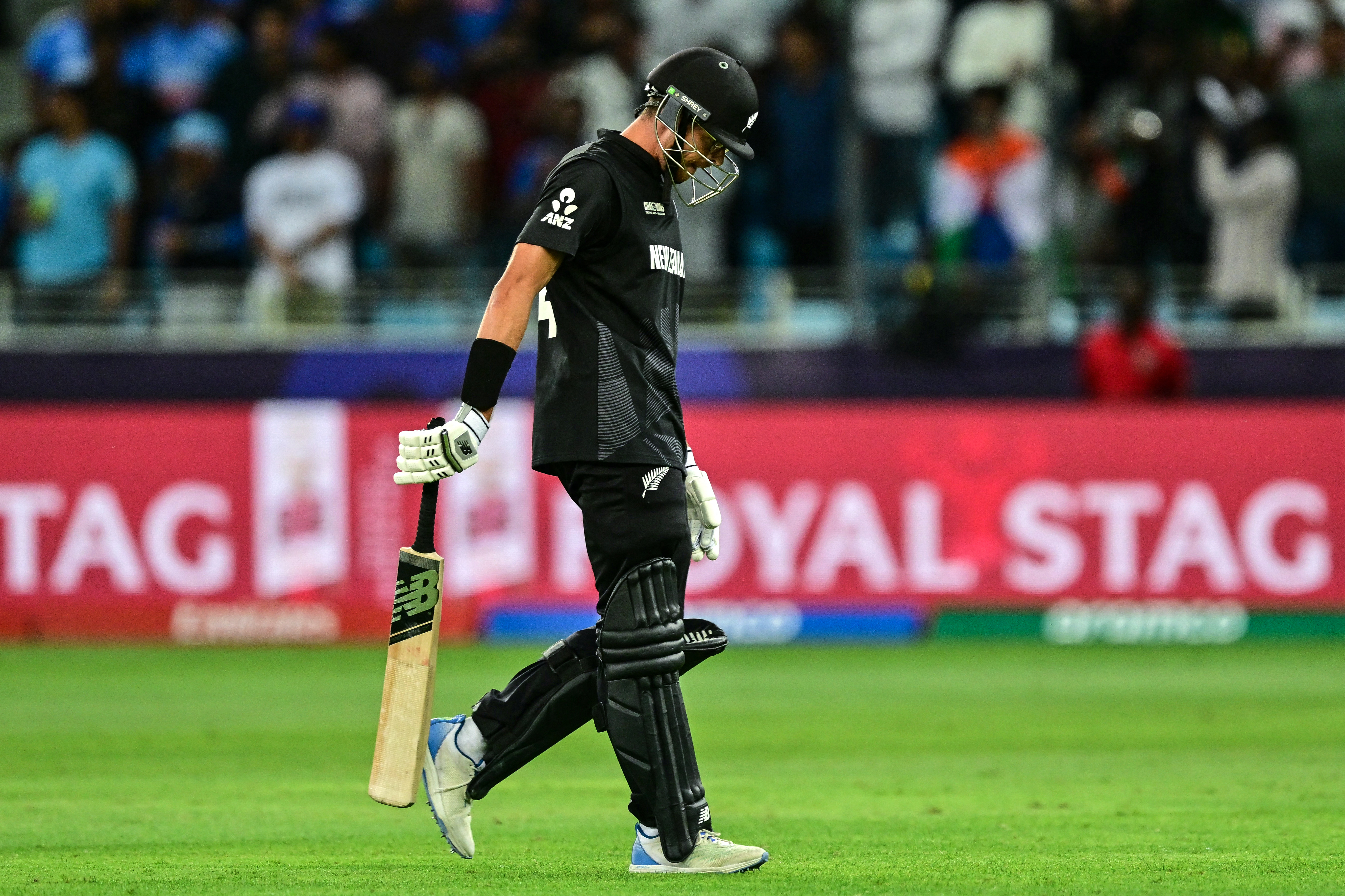 New Zealand's captain Mitchell Santner walks back to the pavilion after his dismissal during the ICC Champions Trophy clash with India. Photo / AFP