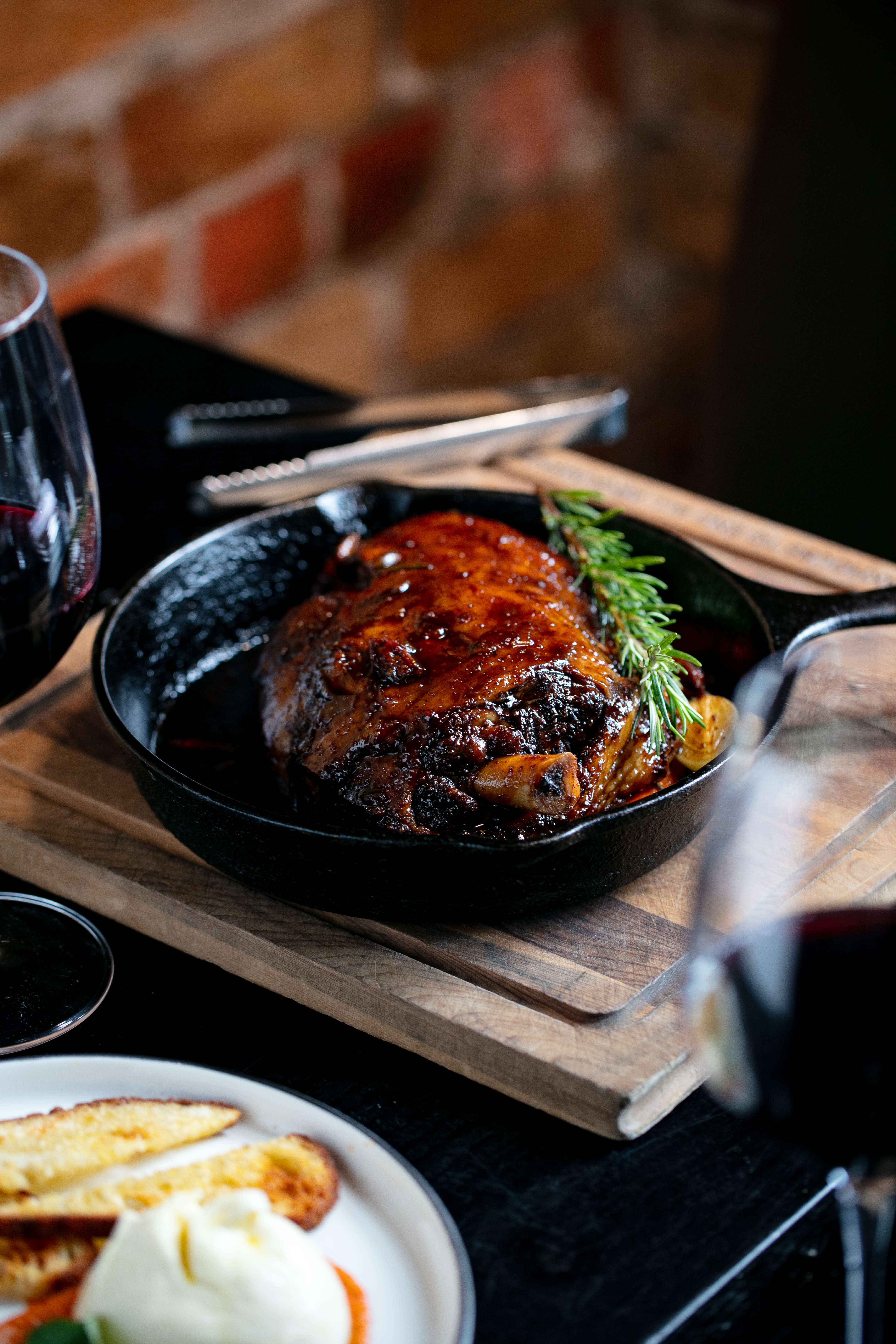 The lamb shoulder is served in a blackened skillet at Jervois Steak House. Photo / Babiche Martens