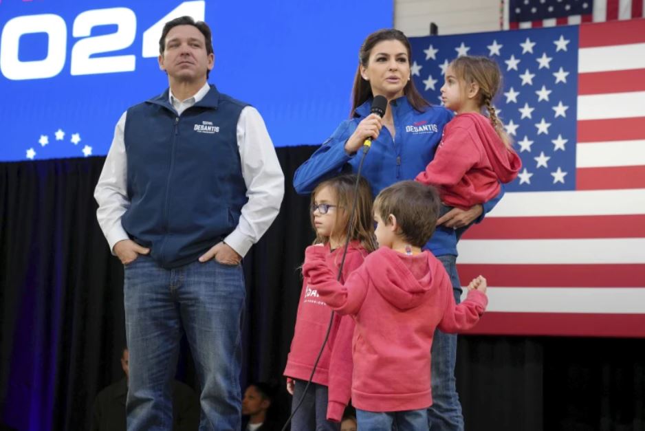 Republican presidential candidate and Florida Governor Ron DeSantis (left) and his wife Casey carrying daughter Mamie, during a campaign event in Myrtle Beach, South Carolina. In the foreground are the couple's other two children, Madison (left) and Mason.  Photo / AP