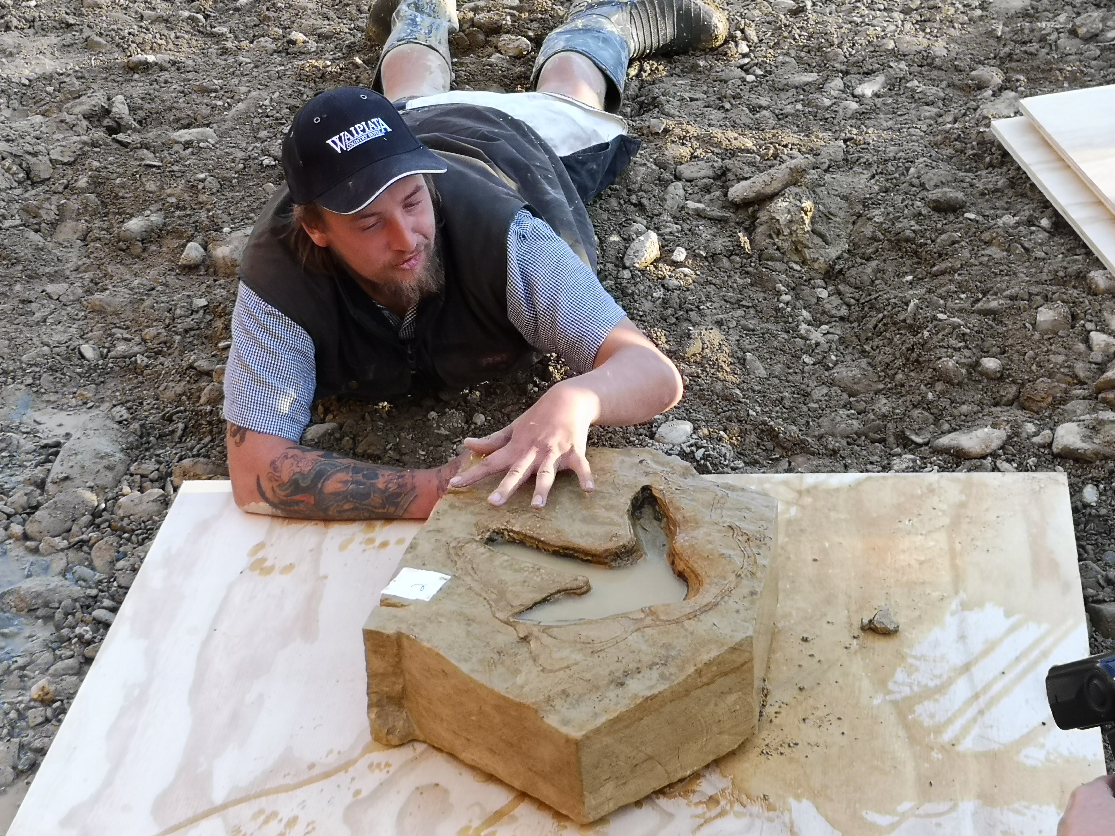 Ranfurly tractor driver Michael Johnston with one of the fossilised moa footprints he discovered in the bed of the Kyeburn River in Maniototo, Otago in March 2019. The footprints were later found to be first documented in the South Island – and the second-oldest confirmed to date. Photo / Otago Museum