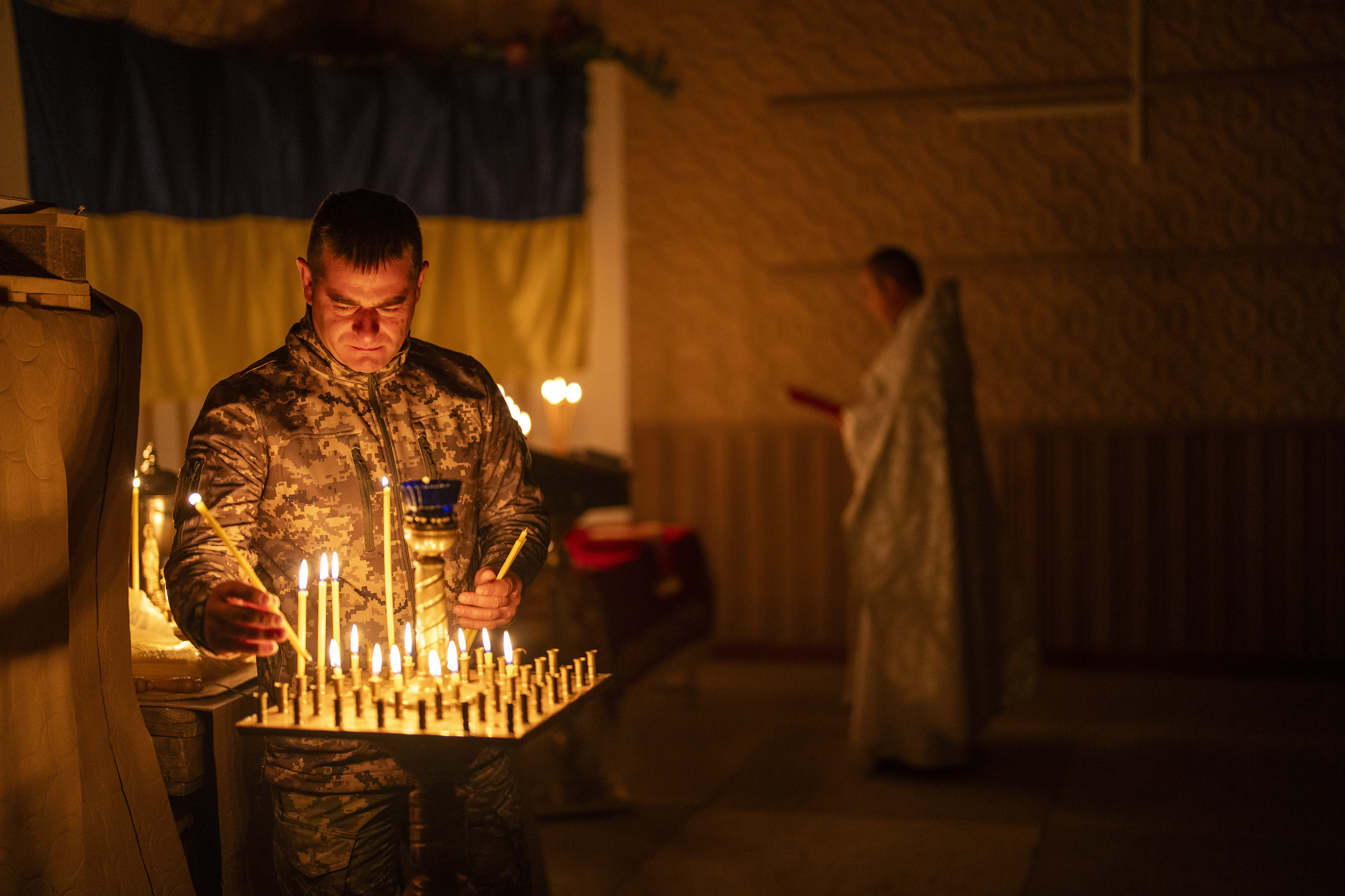 A Ukrainian serviceman of the 72nd Separate Mechanised Brigade, lights candles during a Christian Orthodox Easter religious service, in the Donetsk region of Ukraine. Photo / AP