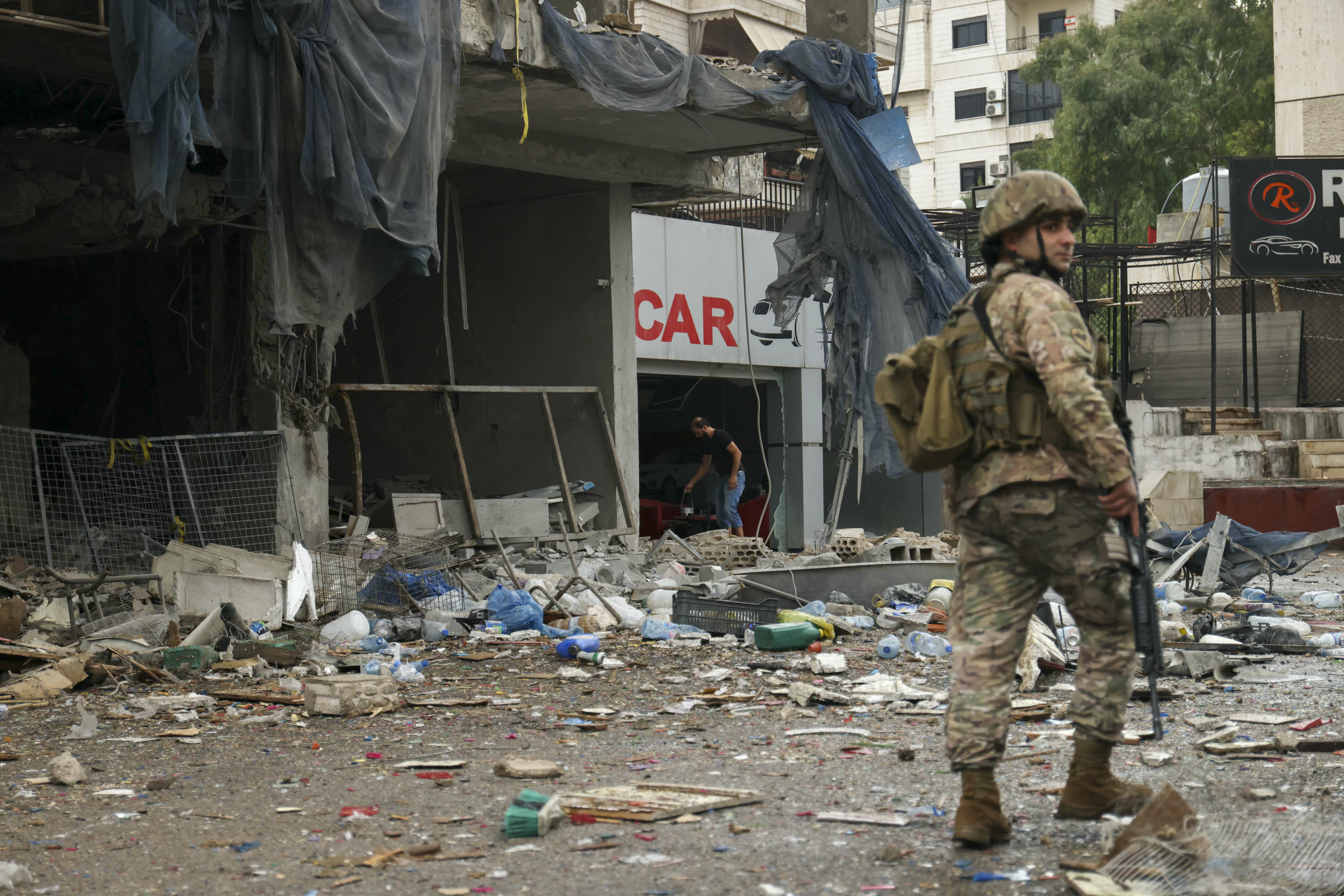 A Lebanese Army soldier walks outside a building that was targeted in an Israeli airstrike in Beirut's southern suburbs yesterday. Photo / AFP