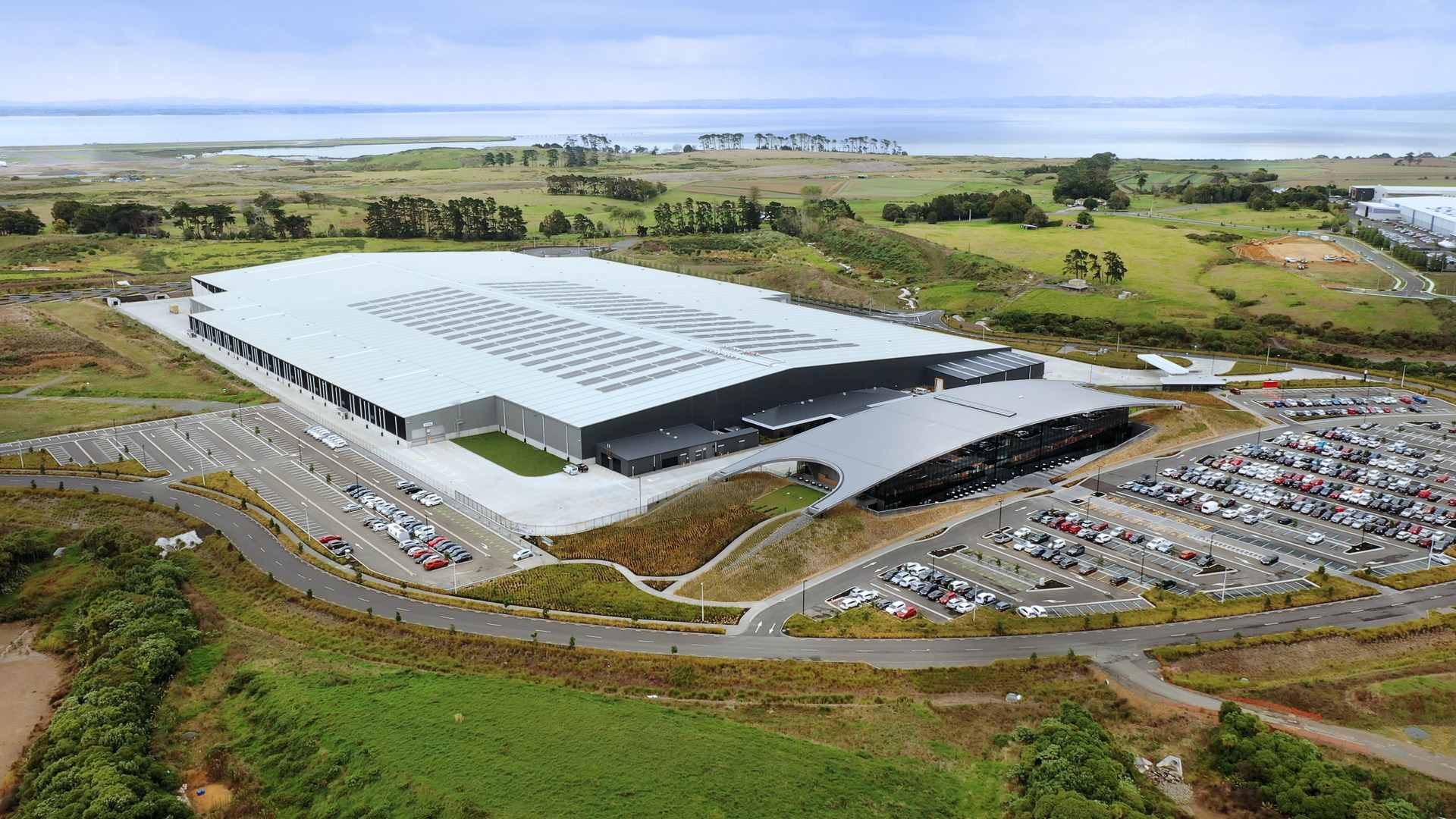 The 7.8ha distribution centre (left) beside the 9000sq m head office (right) with its arc roof. Photo /supplied