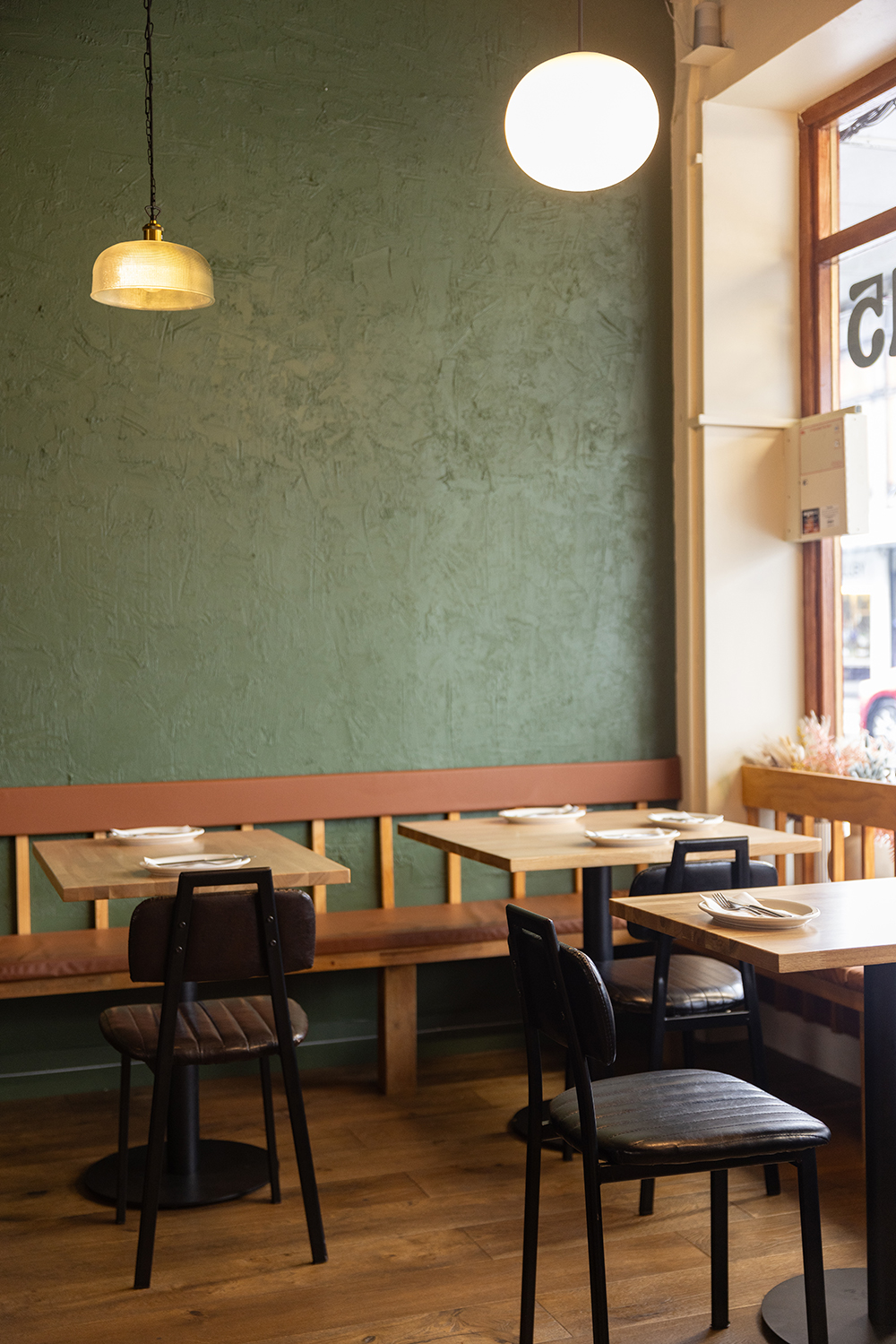 Kookoo is replete with blonde tables and dark green walls on Dominion Road. Photo / Babiche Martens