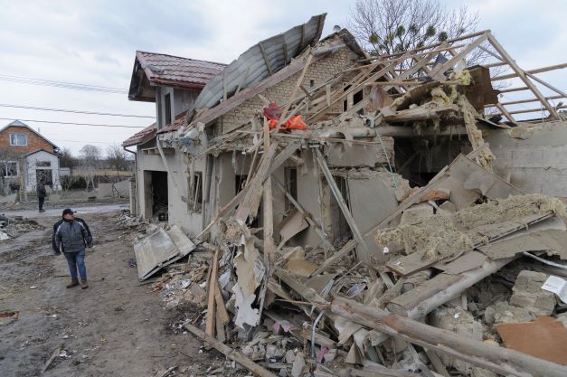 A villager passes by debris of private houses ruined in Russia's night rocket attack. Photo / AP