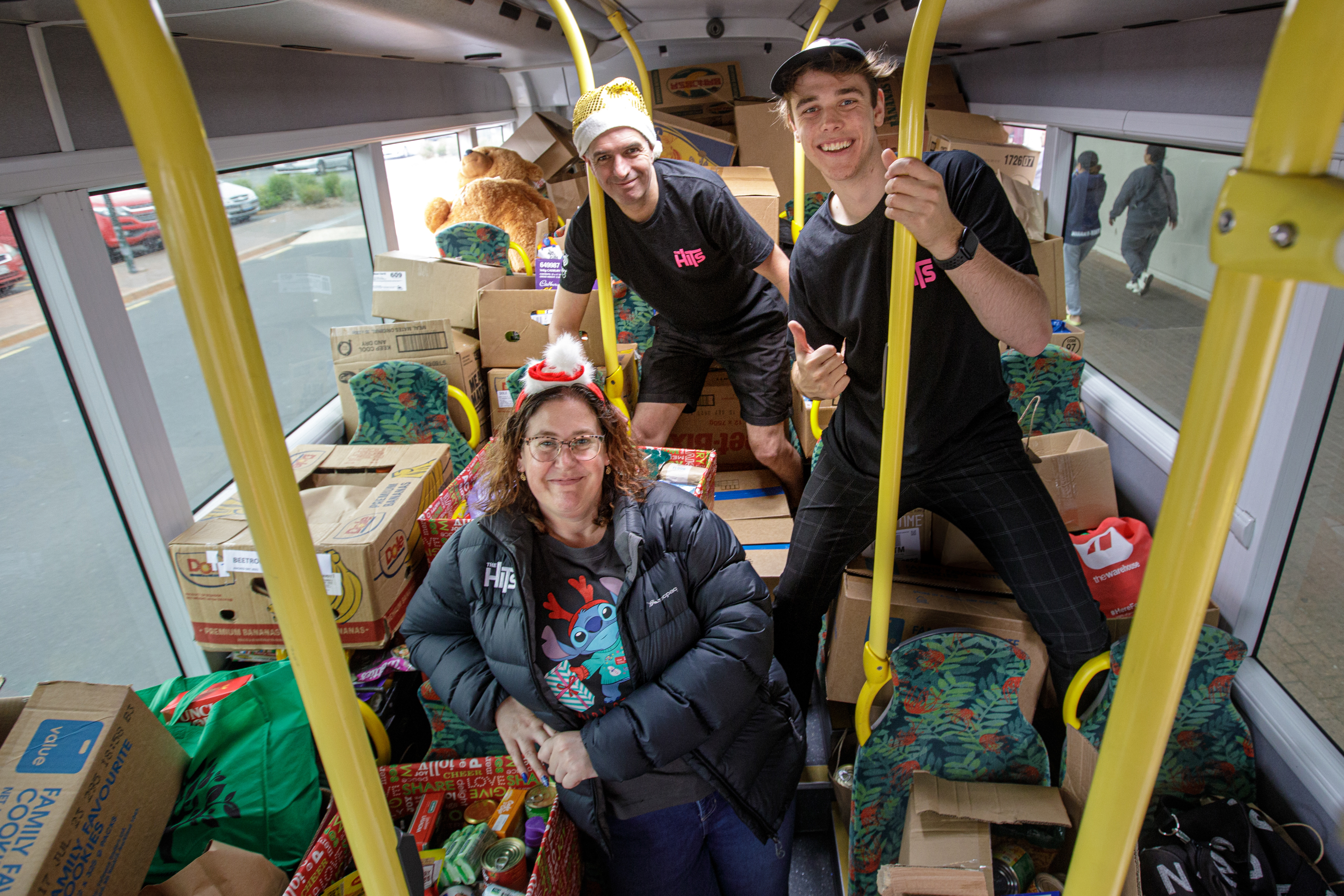 Rotorua has given generously to the foodbank. Pictured are Katie Hickey (front) Paul Hickey (back) and Hamish Gleeson during Fill the Bus. Photo / Mead Norton