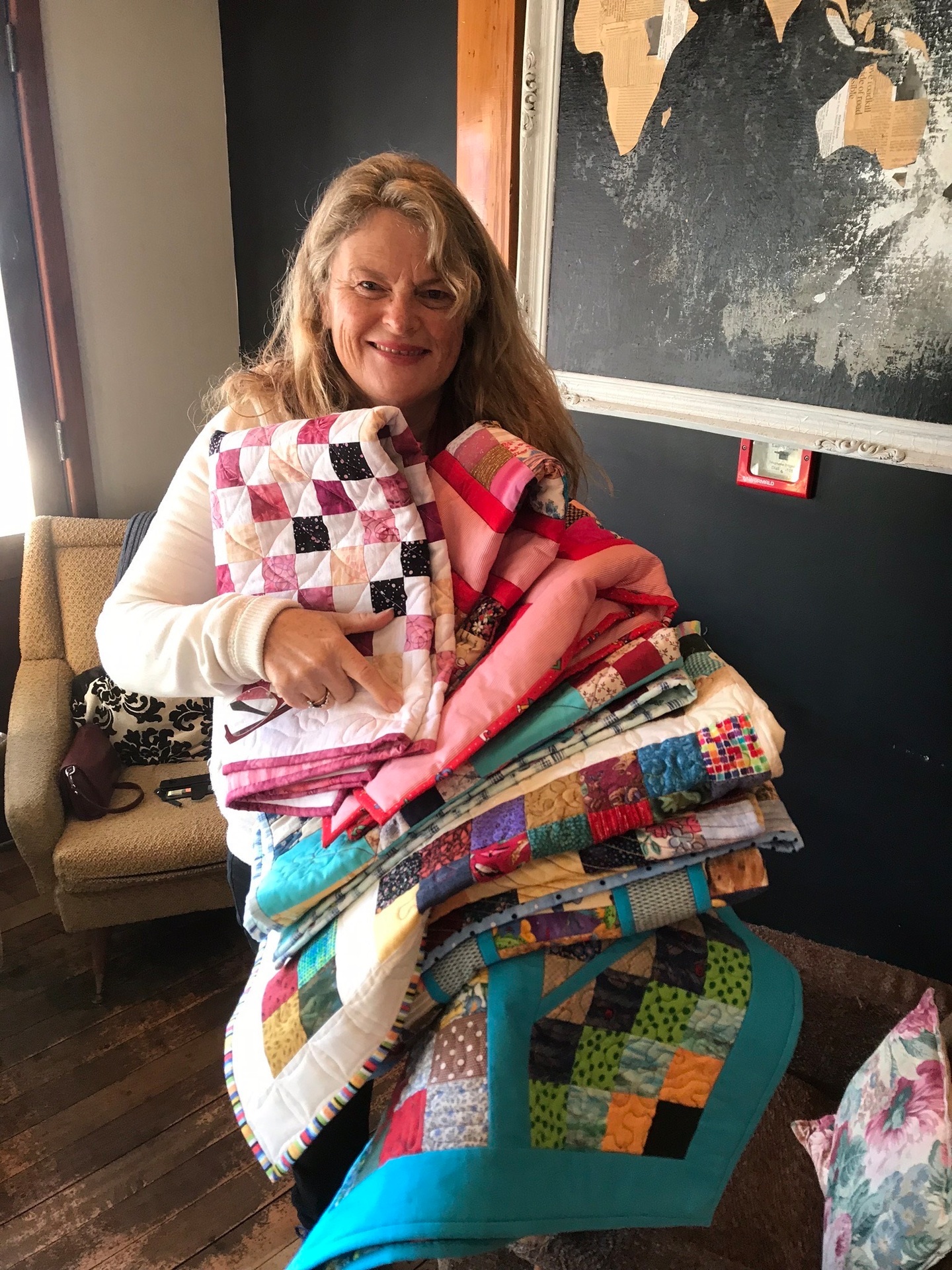 Debbie Sutcliffe from Foster Hope accepts quilts from the Bald Angels.