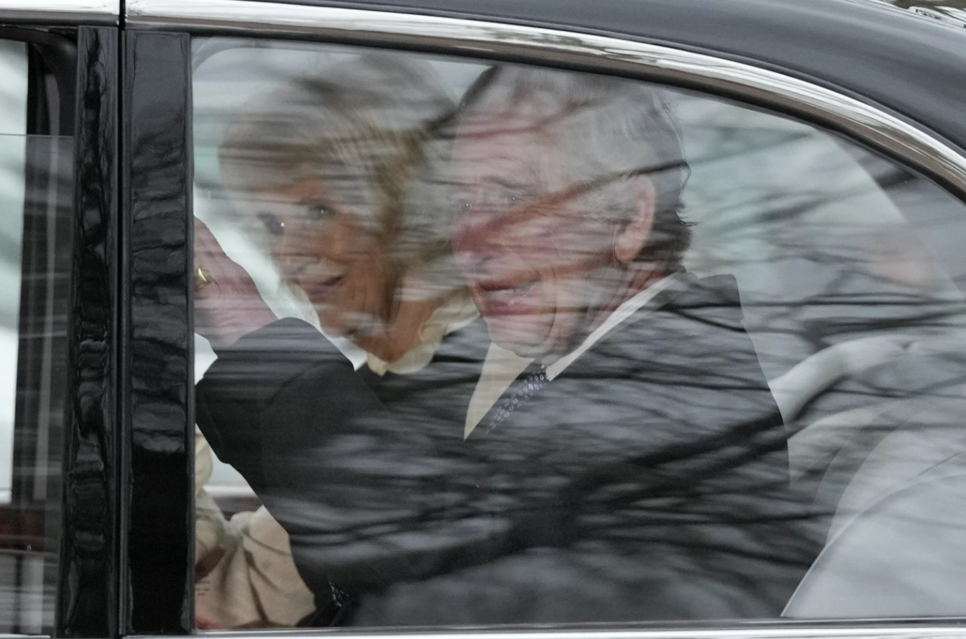 King Charles waves as he and Queen Camilla leave Clarence House by car. Photo / AP