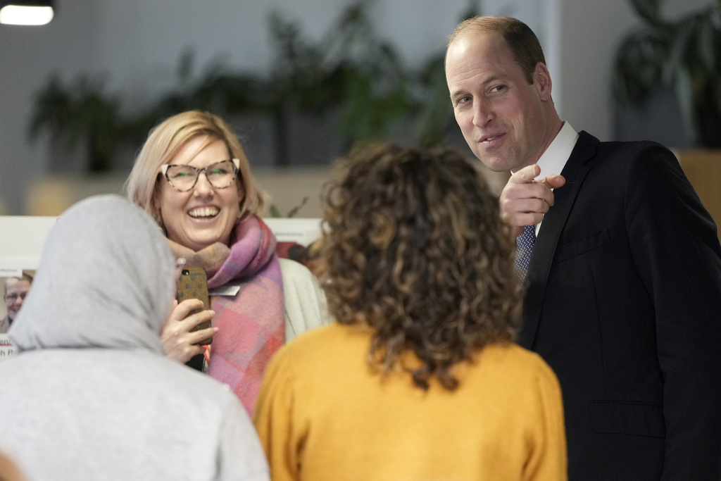 Prince William with British Red Cross workers at their headquarters in London. Photo / AP