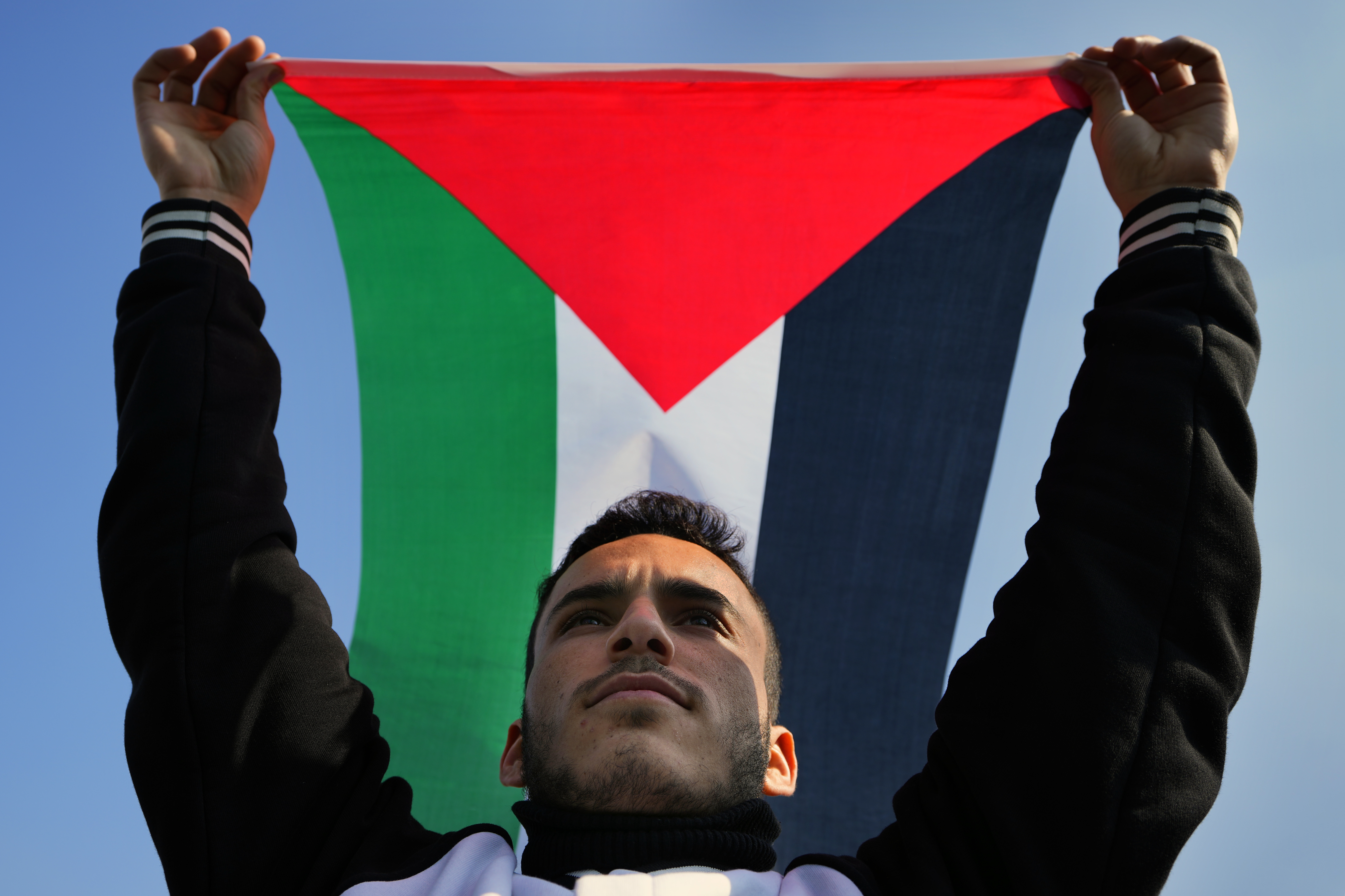 A demonstrator holds up a Palestinian flag during a protest to demand a ceasefire and support Palestinians in the Gaza Strip. Photo / AP