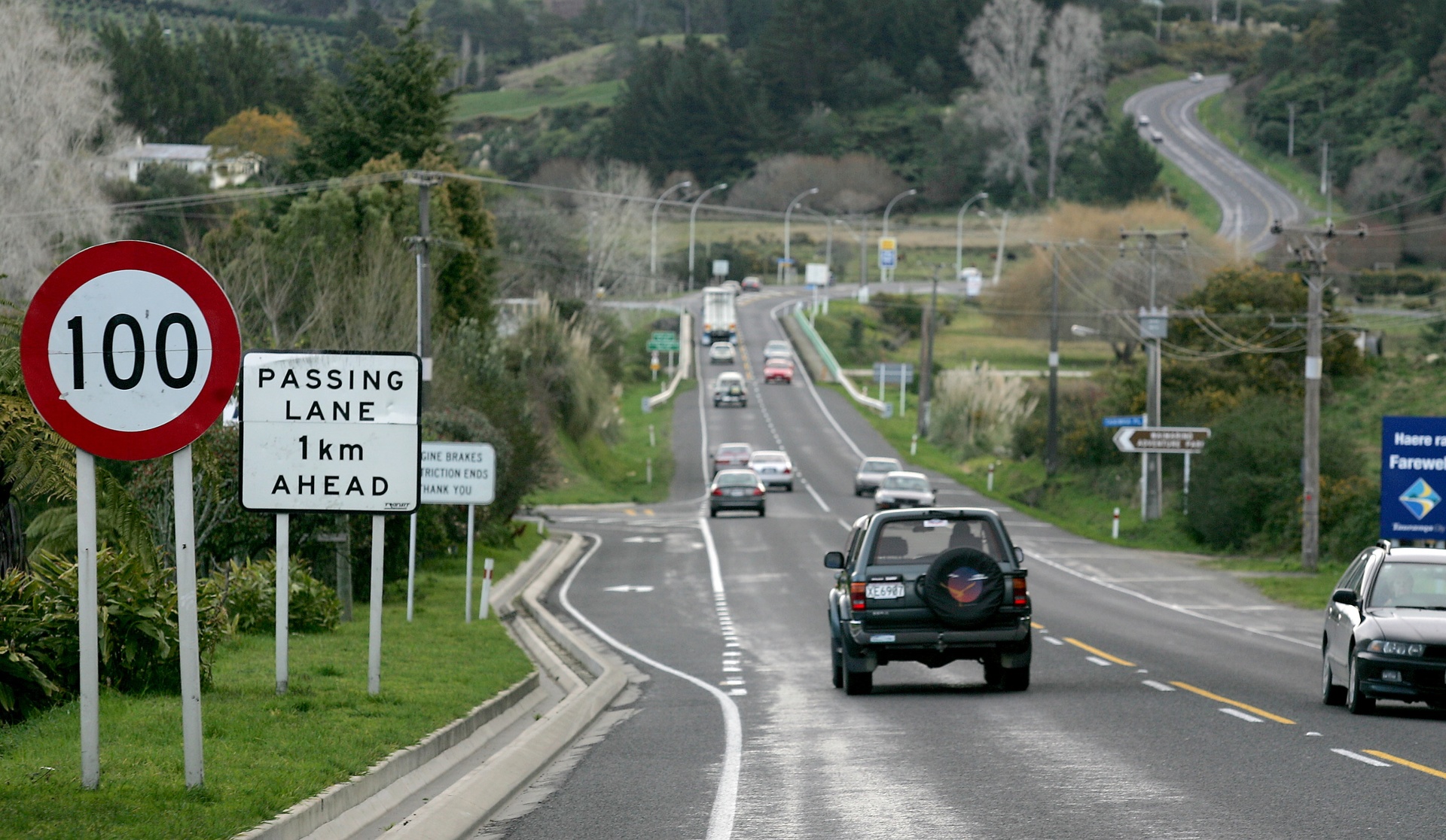 Signs, cars and passing lanes ... a typical New Zealand highway. Photo / John Borren