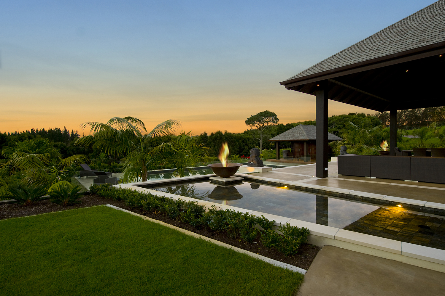 Tropical trees and palms create a holiday feel around a swimming pool, says Tracy Chalmers. Photo / Supplied