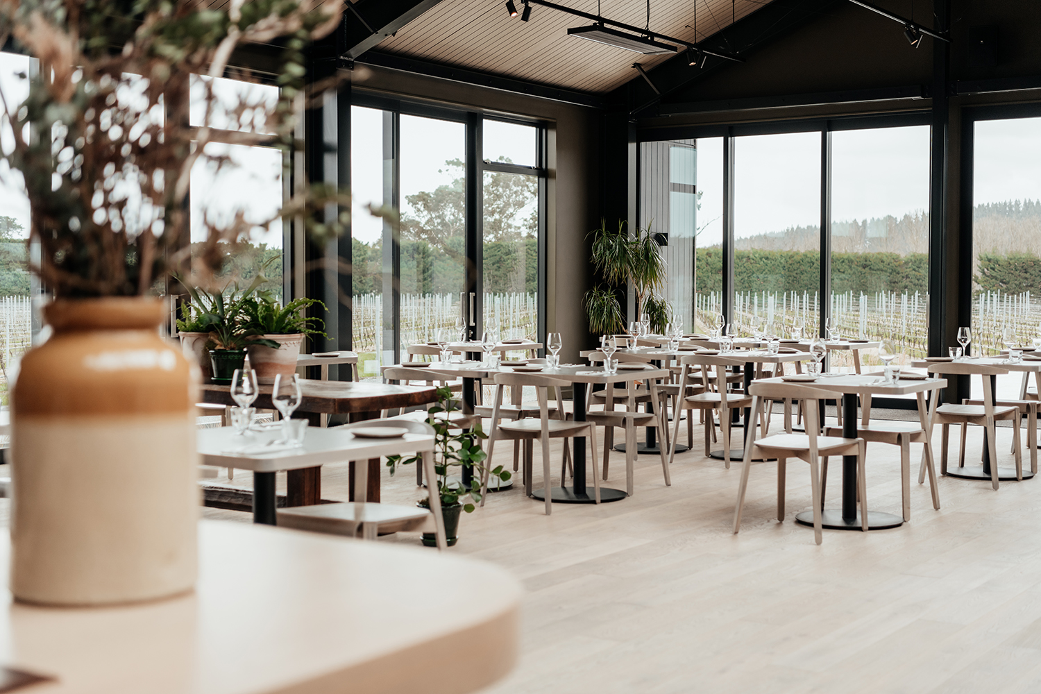 The open dining room looks out to Te Kairanga’s sprawling vineyard.