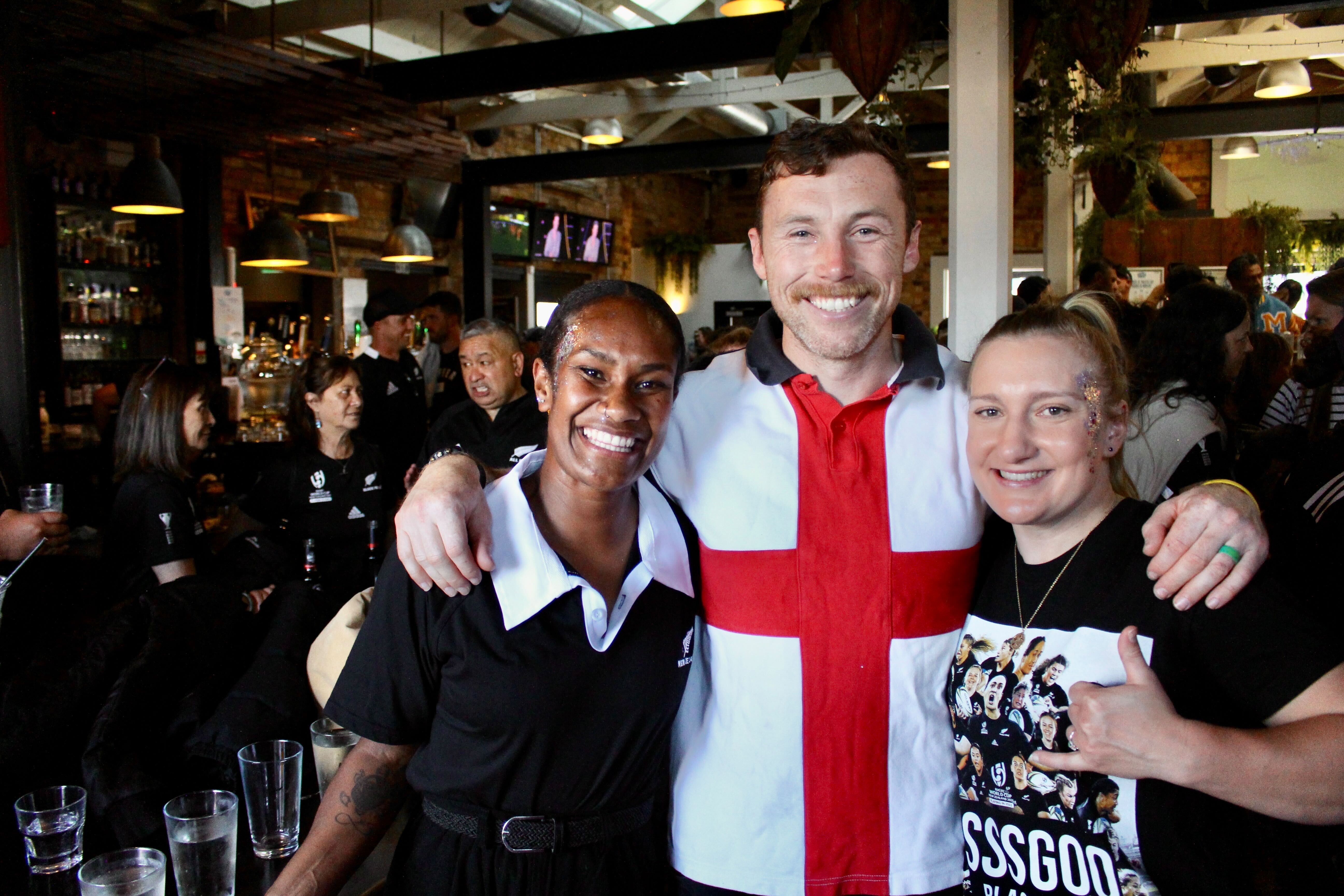 Talei Kidd, left, with Daniel Thompson and a friend at the Kingslander pub near Eden Park. Kidd is going to tonight’s final to support her friend, Black Fern Kennedy Simon. Photo / Jed Bradley