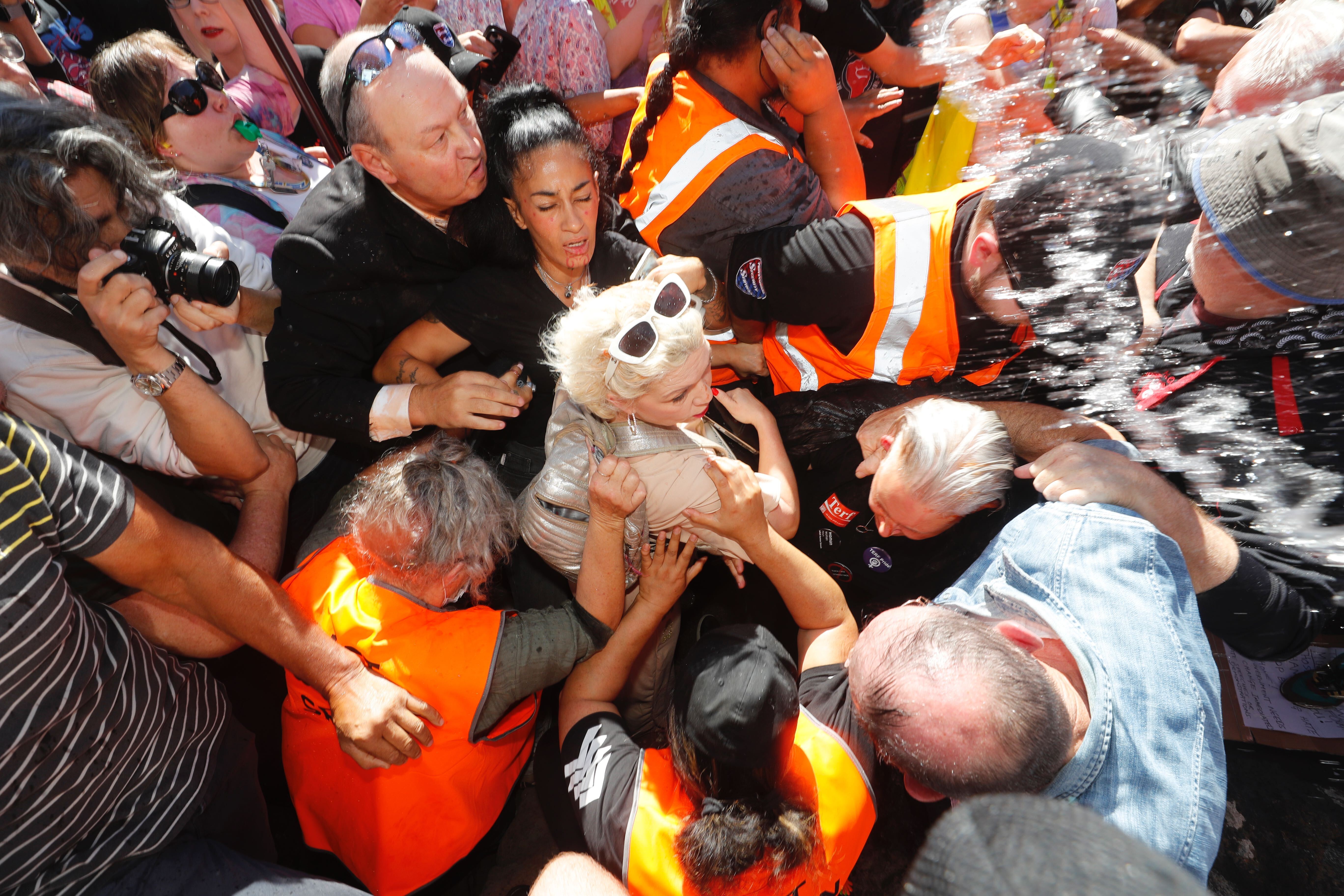 Posie Parker is rushed from Albert Park. Photo / Dean Purcell