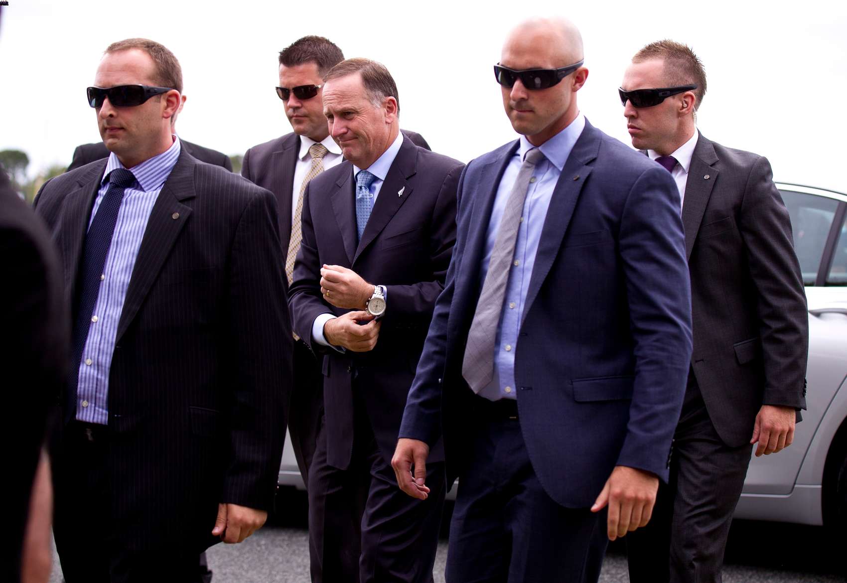 Prime Minister John Key arrive at Te Tii Marae, Waitangi, under heavy security in 2014. Photo / Dean Purcell