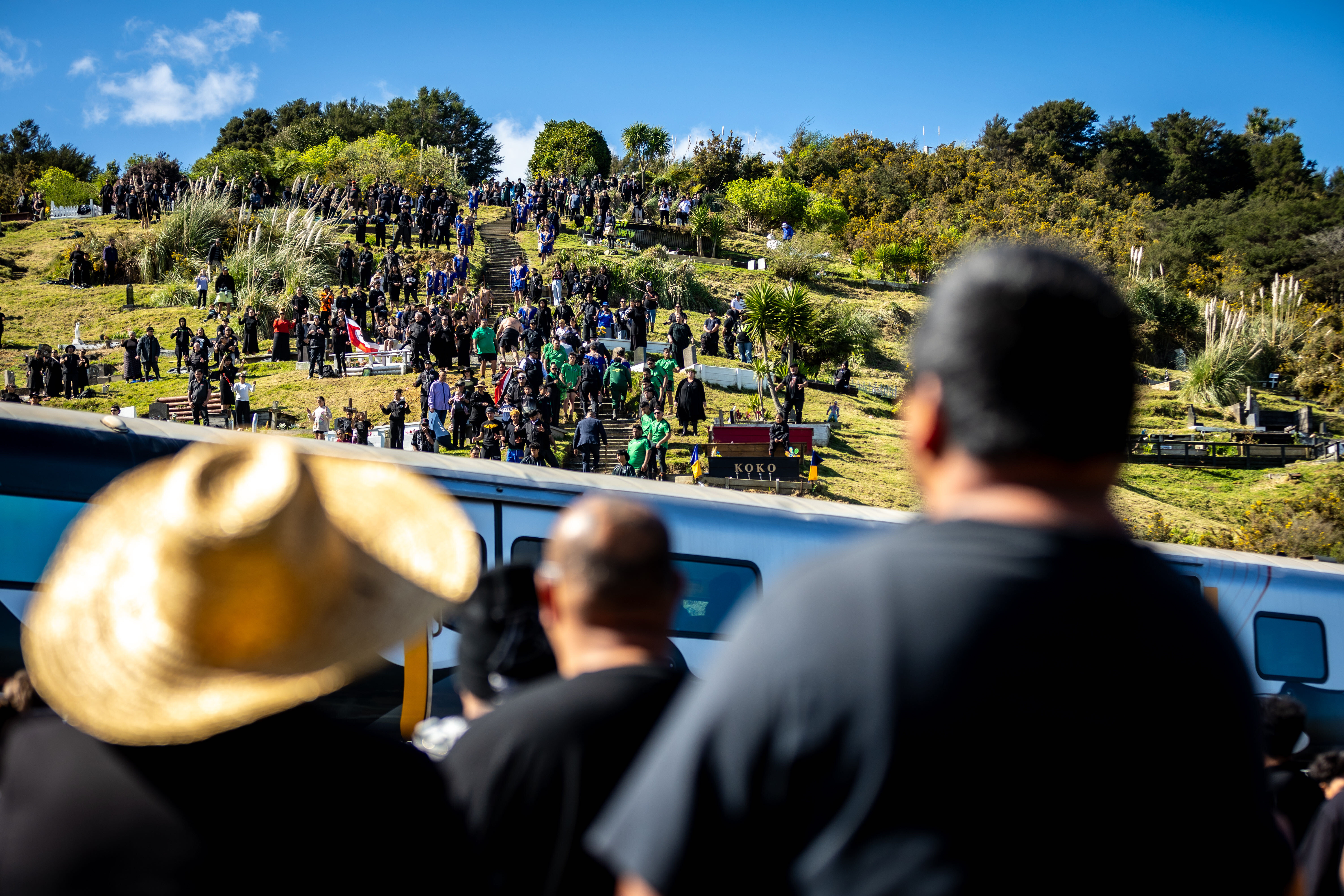 Mourners gather on the urupā at Taupiri Maunga. Photo / Michael Craig