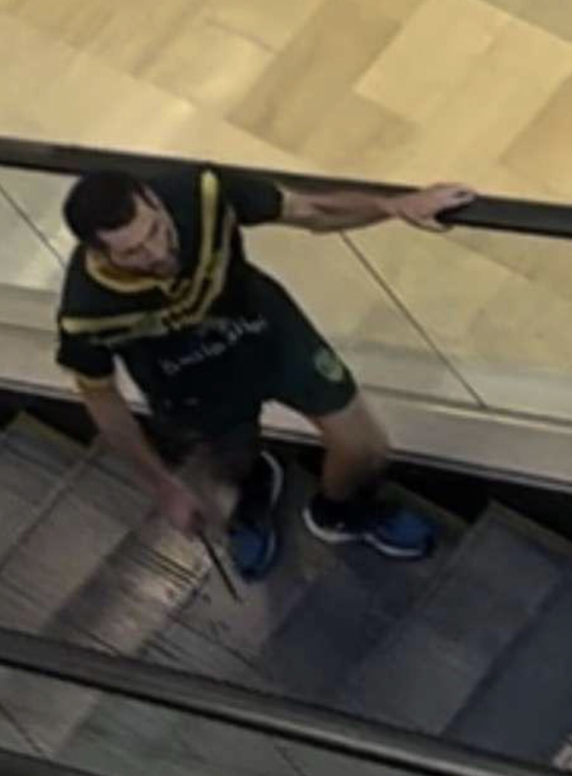 A man armed with a knife walks inside the Bondi shopping mall.  
