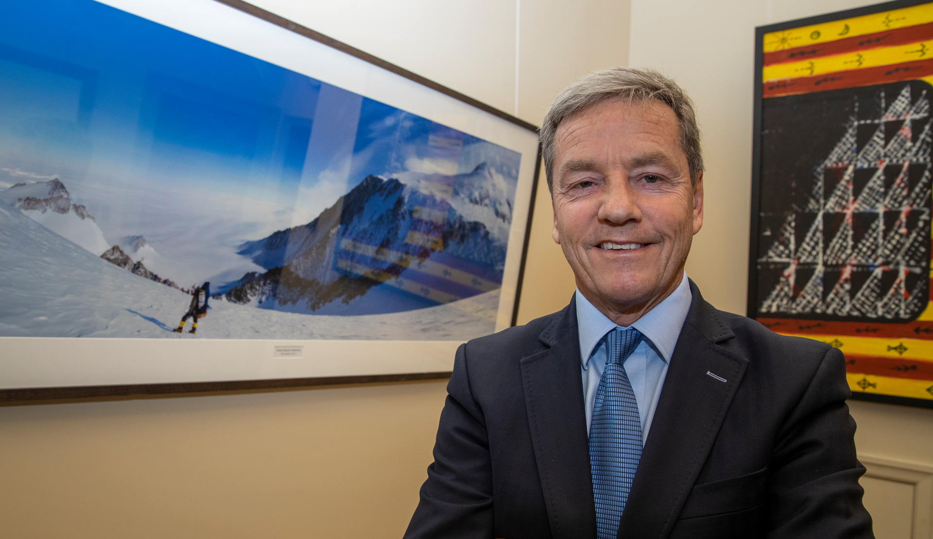 National shadow treasurer Andrew Bayly with a photograph of himself on a mountain in Antarctica which takes pride-of-place in his new office at Parliament. Photo / Mark Mitchell