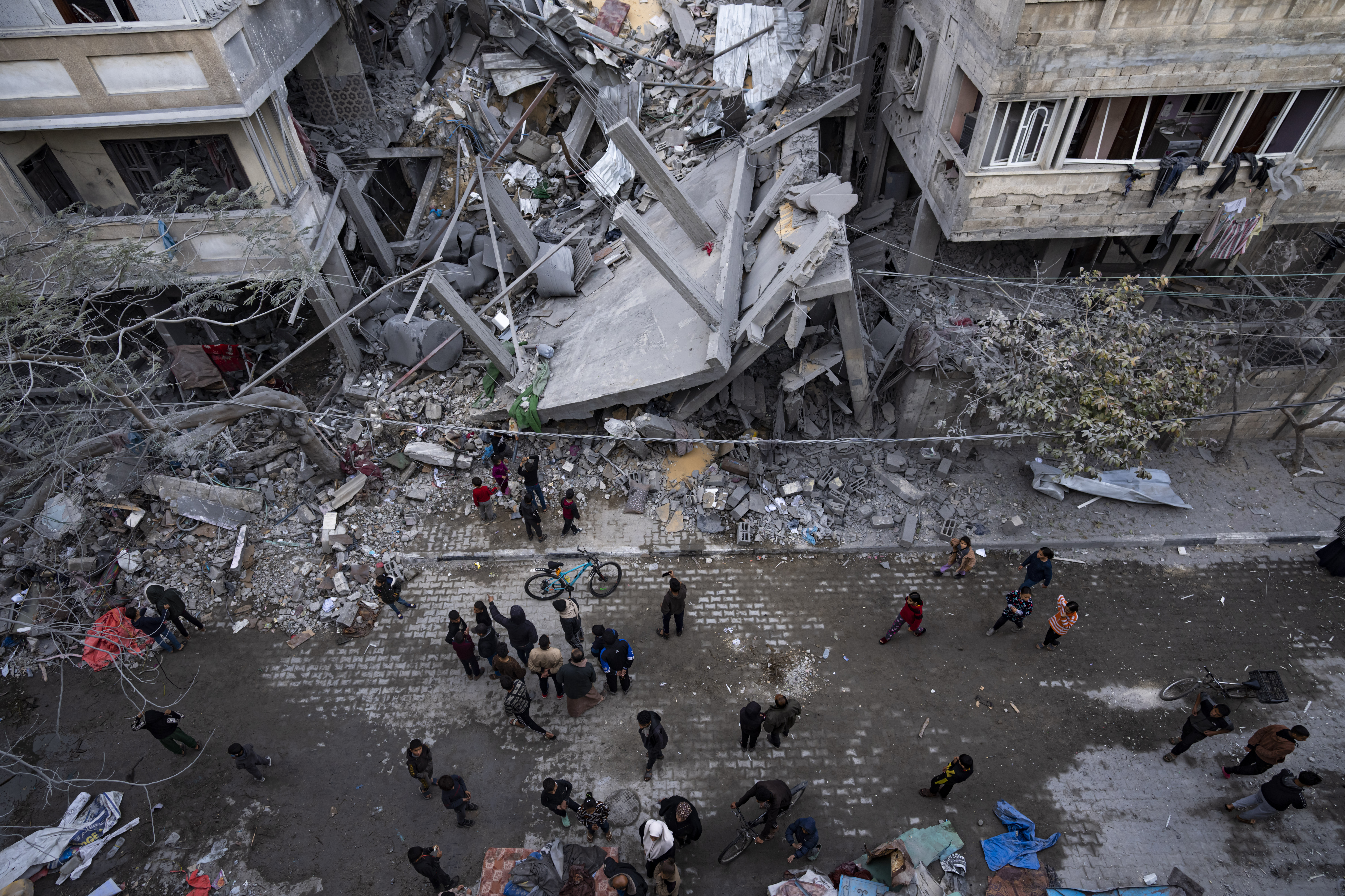 Palestinians inspect the damage of residential buildings after an Israeli airstrike in Rafah. Photo / AP
