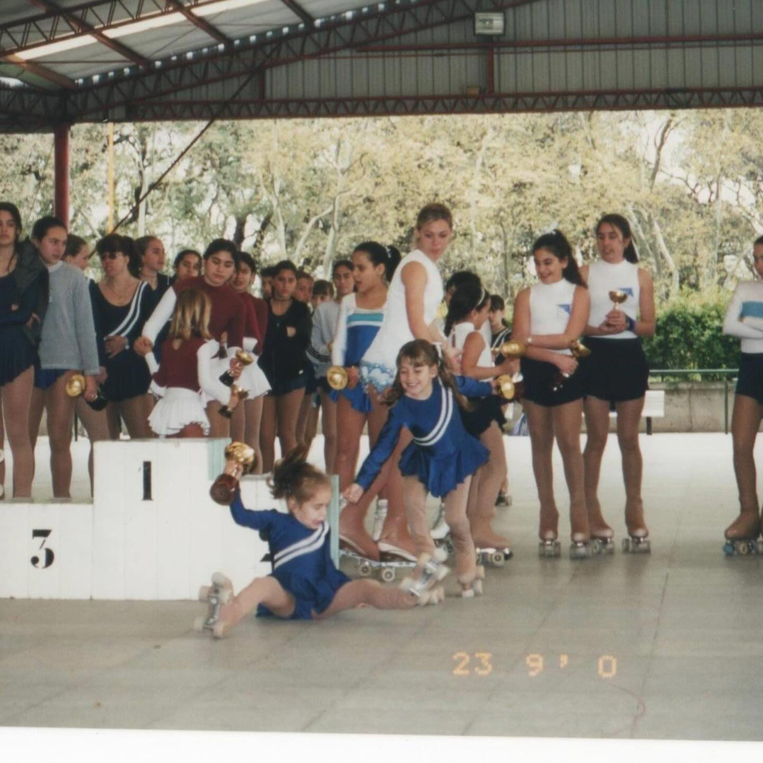 An early skating memory: Macarena falls off a podium after receiving the first-place trophy at a skating competition. Photo / Supplied