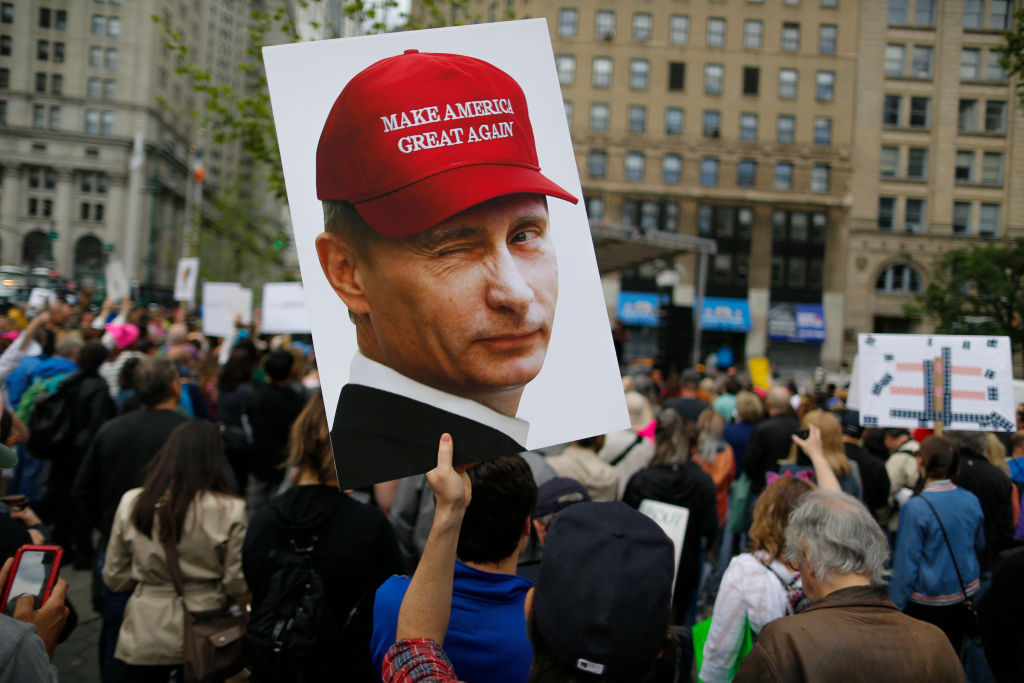 A demonstrator holds up a sign of Vladimir Putin during an anti-Trump 'March for Truth' rally on June 3, 2017 in New York City. Photo / Getty