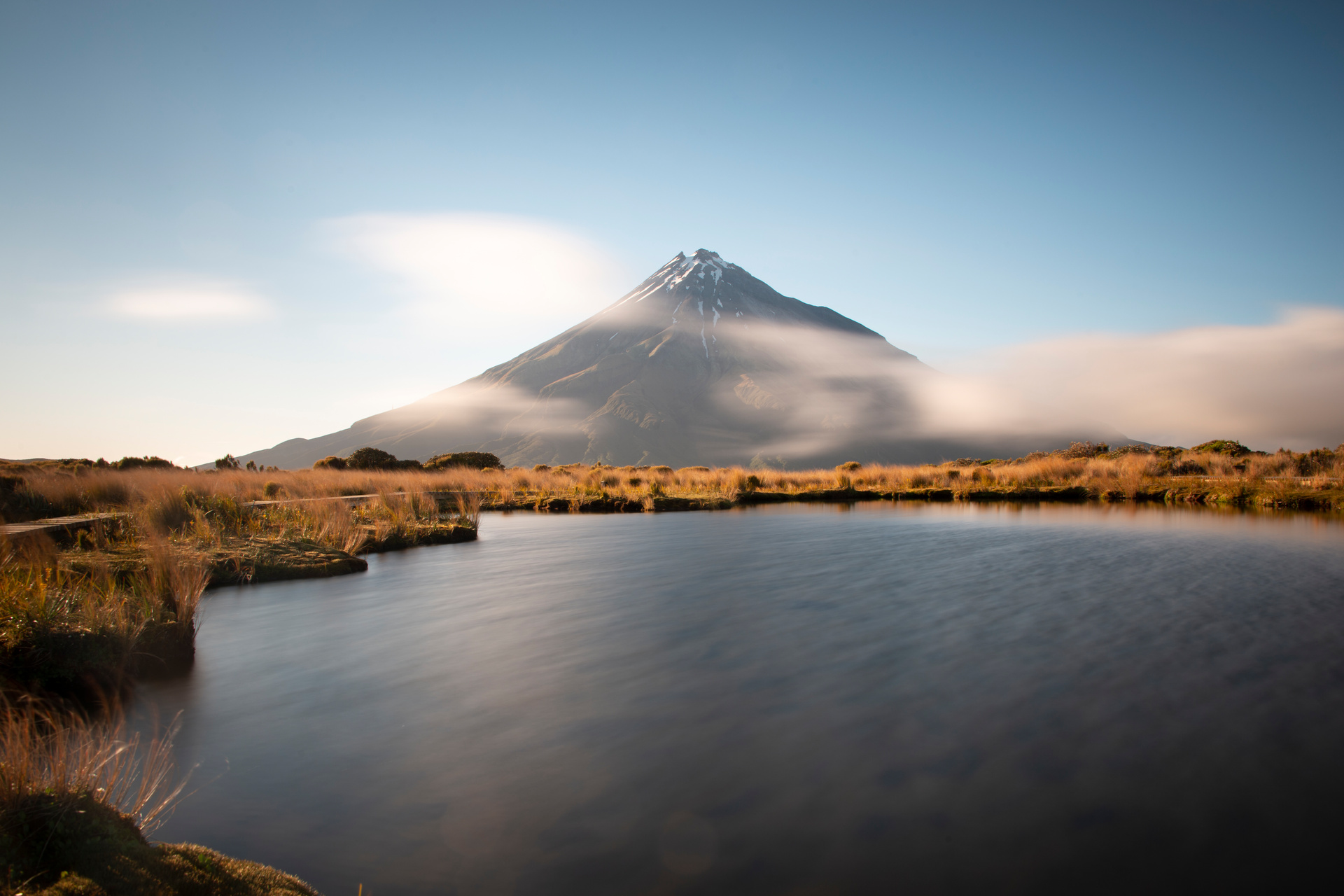 Majestic Mount Taranaki with fast moving clouds, seen from the Pouākai track. Photo / 123rf