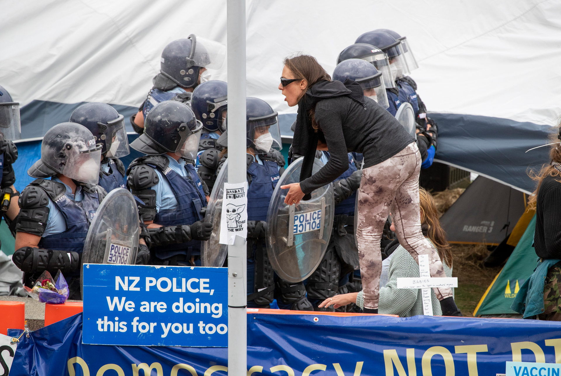 A lone protester faces police on the final day of the Covid-19 Convoy protest at Parliament. Photo / Mark Mitchell