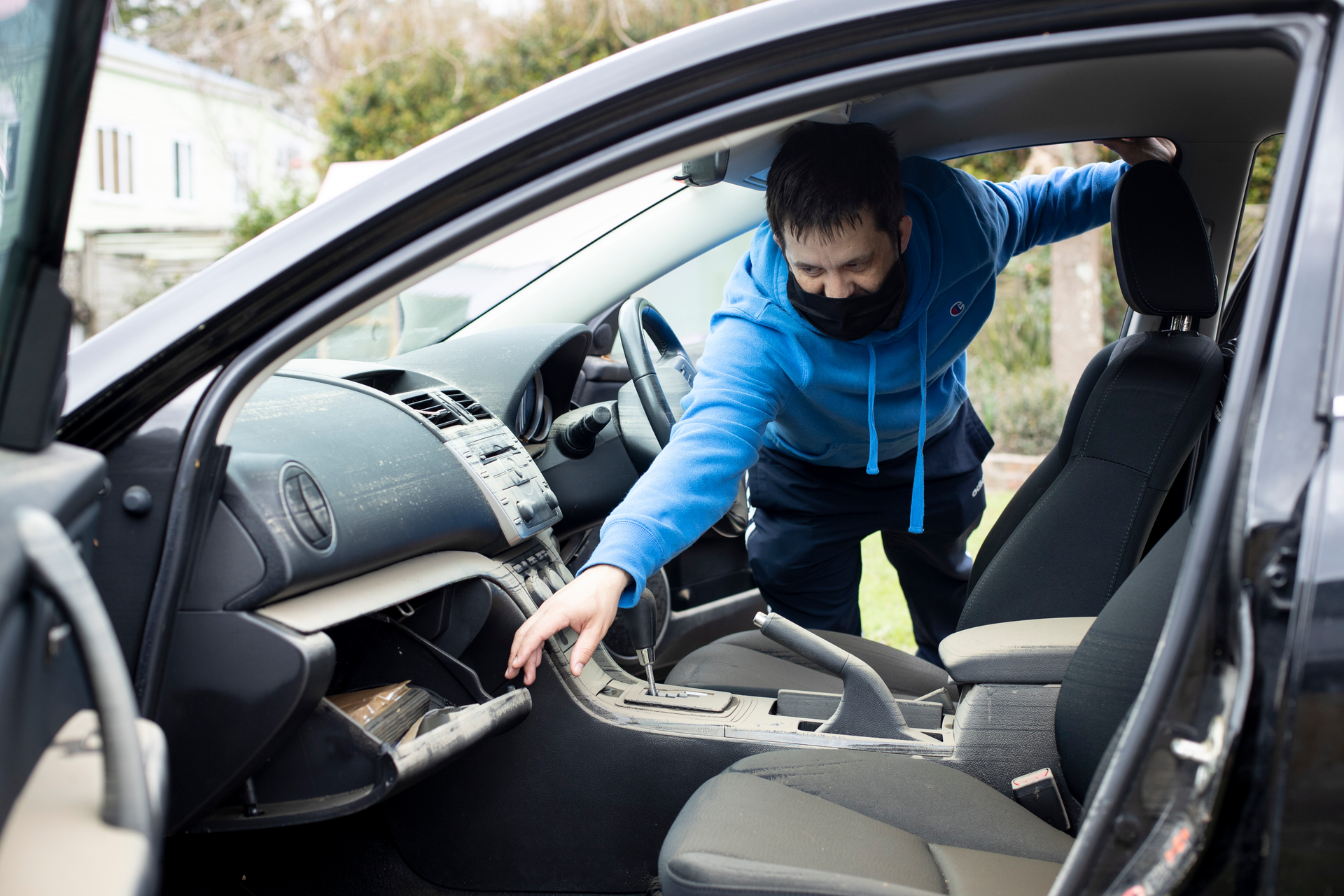 Brendon Deacon looks at his car at his Huapai property which was damaged in flooding. Photo / Dean Purcell