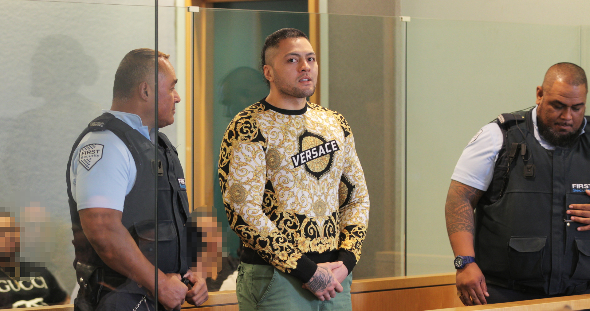 Comancheros vice president Tyson Daniels wears Versace top in gang colours of black and gold at his High Court sentencing. Photo / Michael Craig