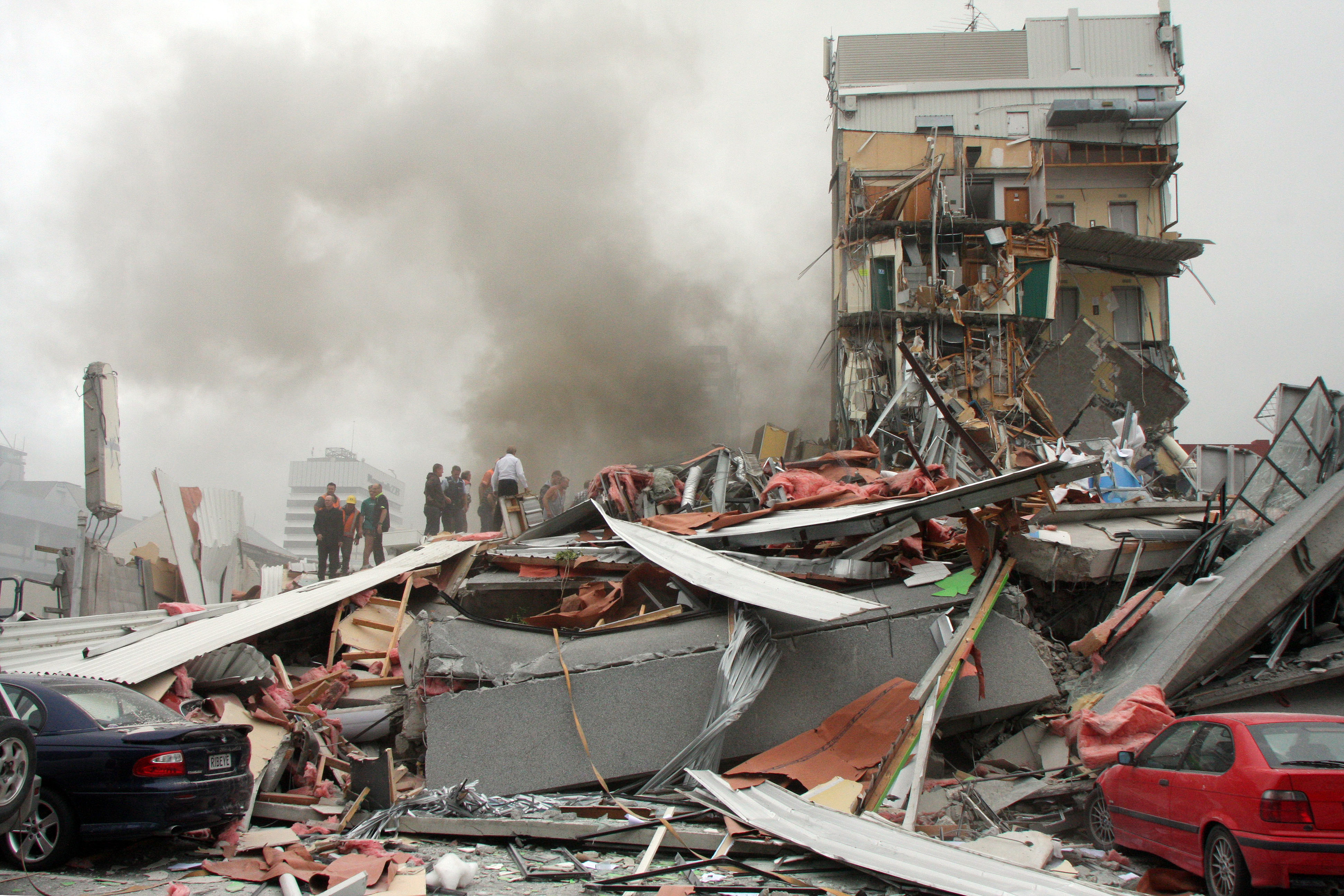 Police and volunteers work to rescue people trapped in the collapsed CTV building. Photo / Geoff Sloan