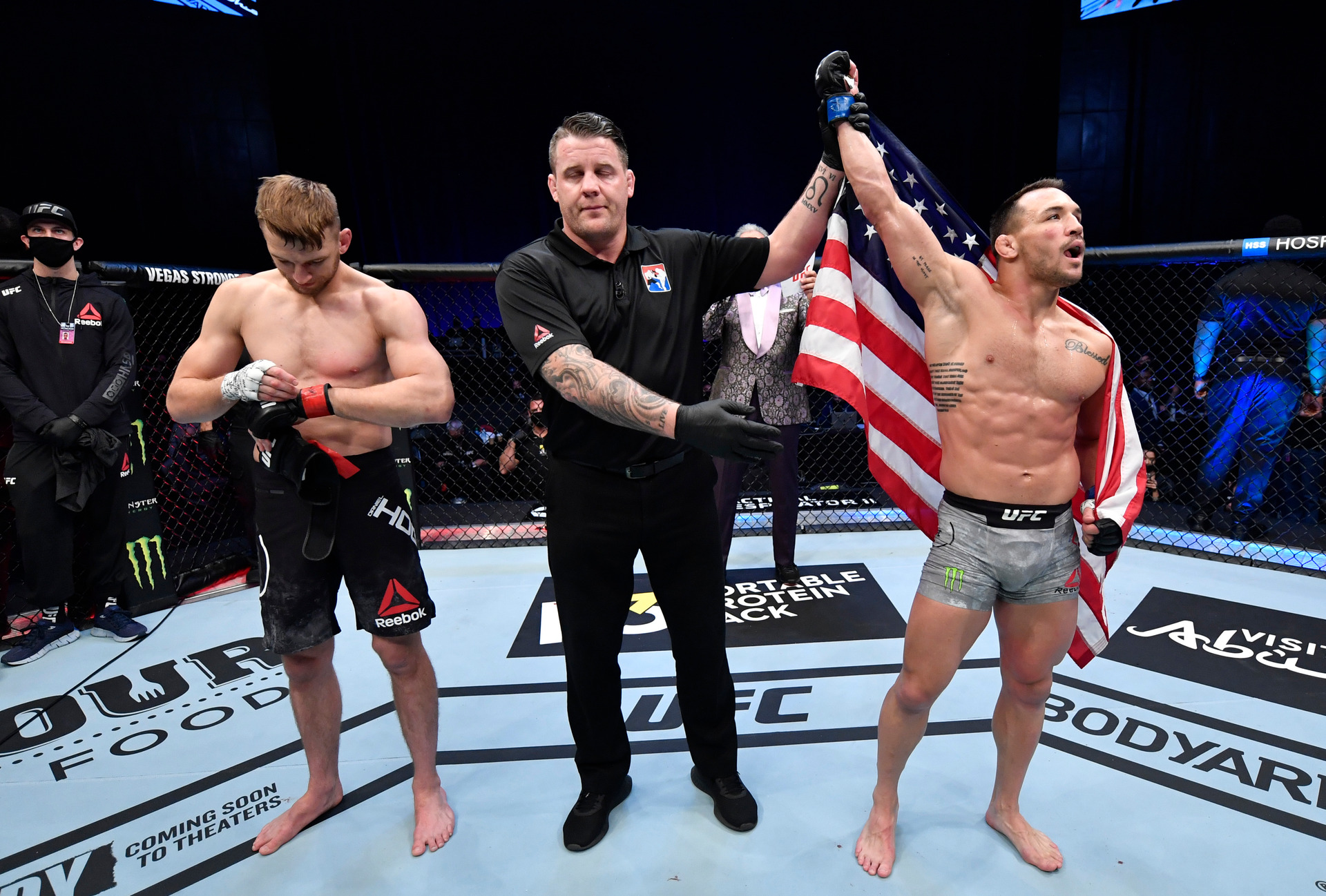 Dan Hooker takes off his gloves after a first-round TKO loss to Michael Chandler. Photo / Getty Images