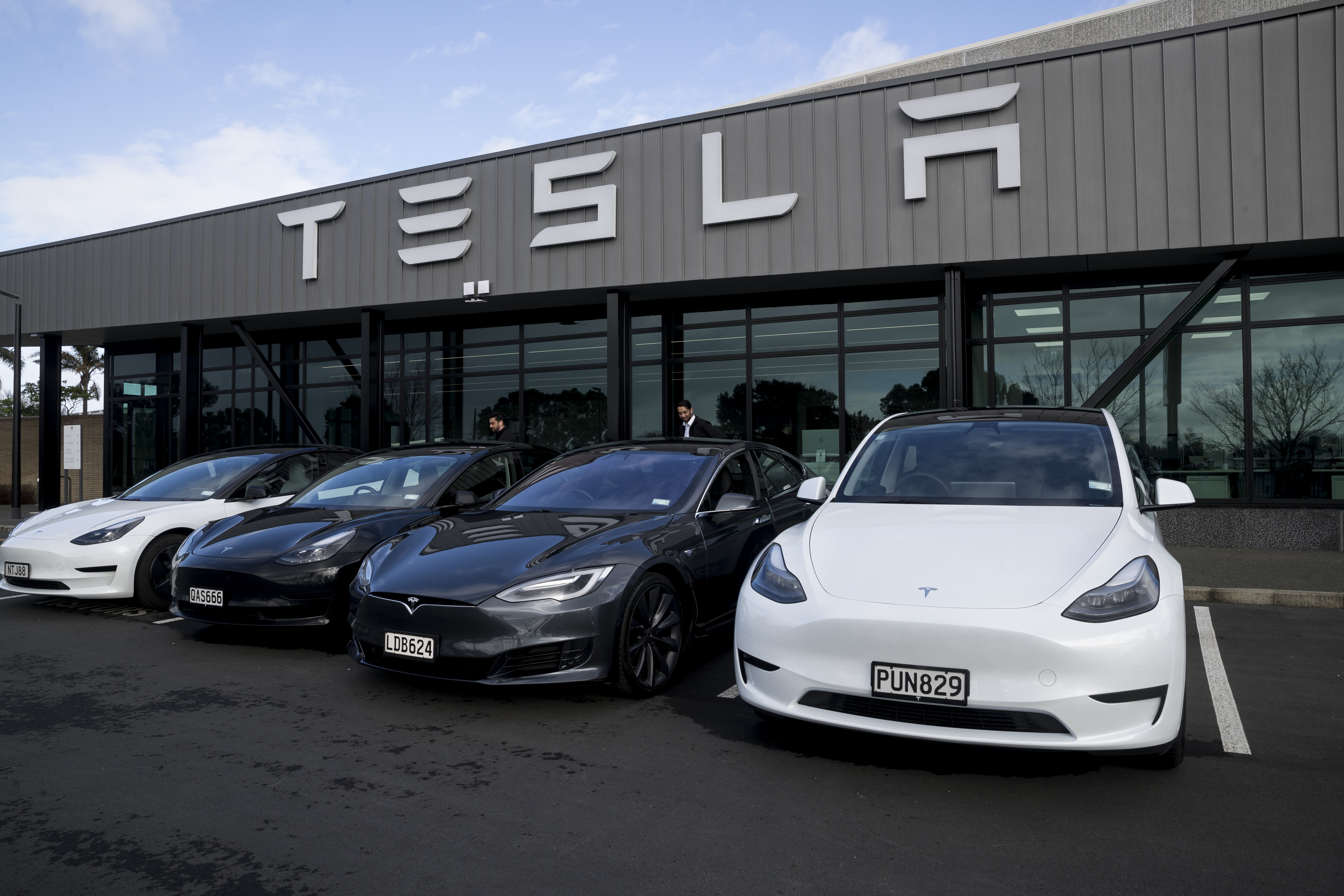 A line-up of Tesla models on display at the front of tesla South. Photo / Dean Purcell
