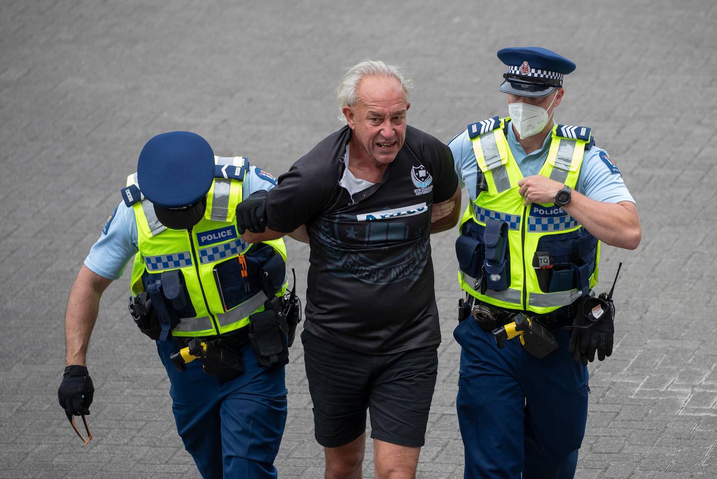 Anti-mandate protester and former Taranaki Regional Council candidate Brett Power is arrested after leading a charge at police lines at Parliament, Wellington. Photo / Mark Mitchell

