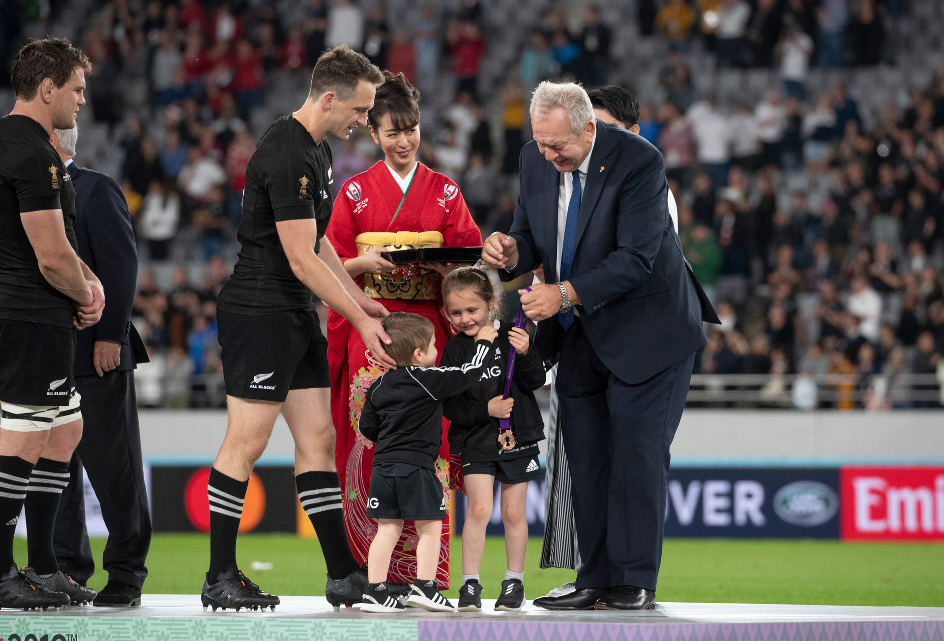 All Blacks wing Ben Smith has his children, Annabelle and Walter, receive his medal from World Rugby chairman Sir Bill Beaumont after the side finished third at the 2019 Rugby World Cup. Photo / Mark Mitchell