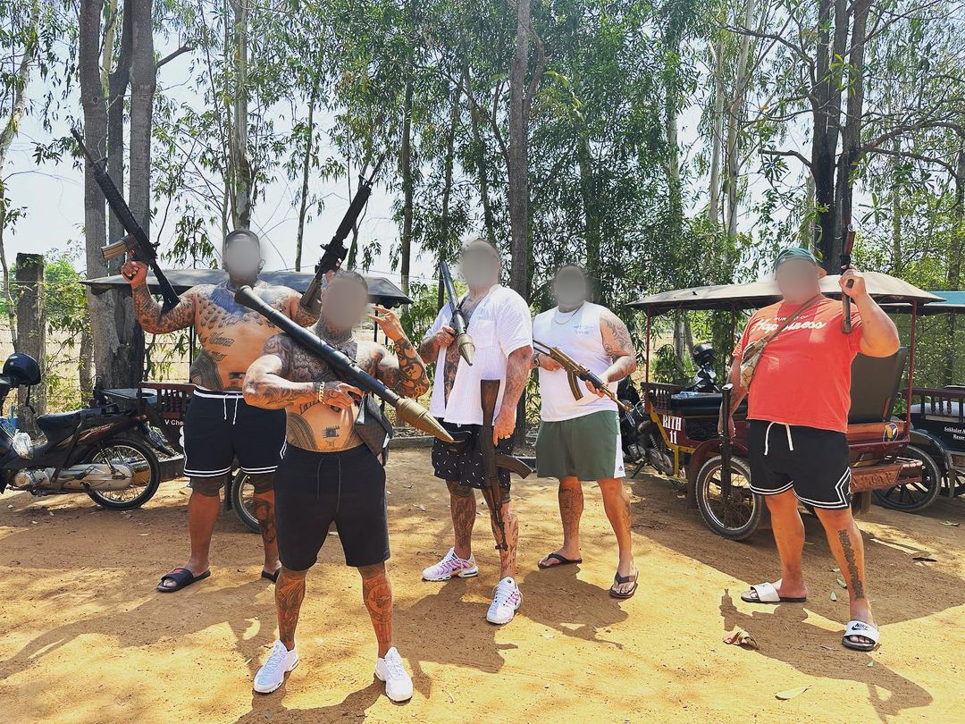 Members of the Head Hunters brandishing firearms and a rocket launcher in Cambodia. 